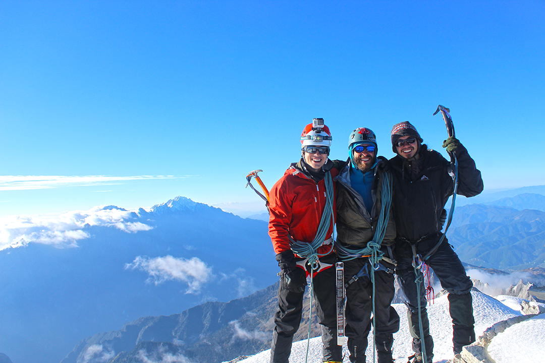 The summit team with Jade Dragon Mountain (玉龙雪山)rising on the other side of Tiger Leaping Gorge (虎跳峡).