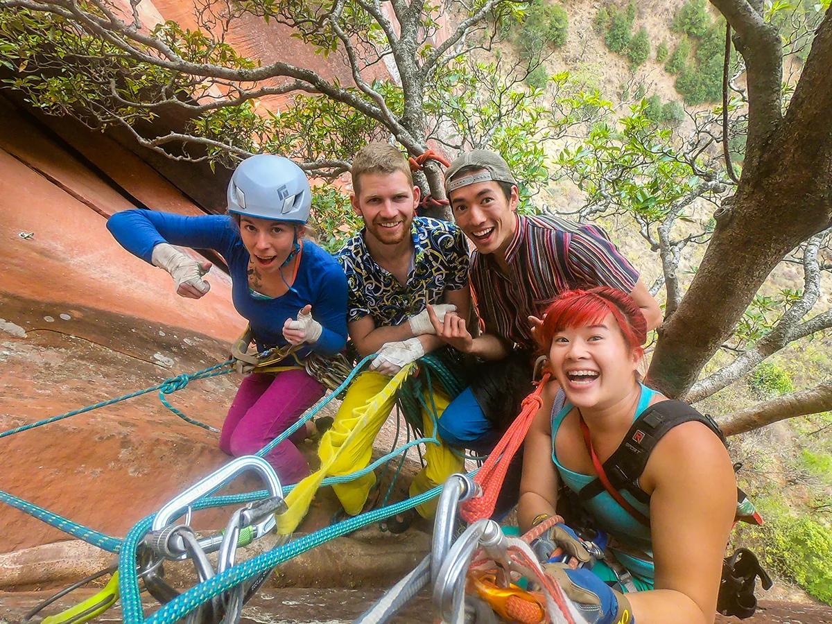Friends at the end of a great day. (left to right) Ashley Cracroft, Danny Parker, Ryder Stroud, and Irene Yee all ready to rappel to the ground for a good meal back in Liming village!© Irene Yee/Lady Lockoff Photography