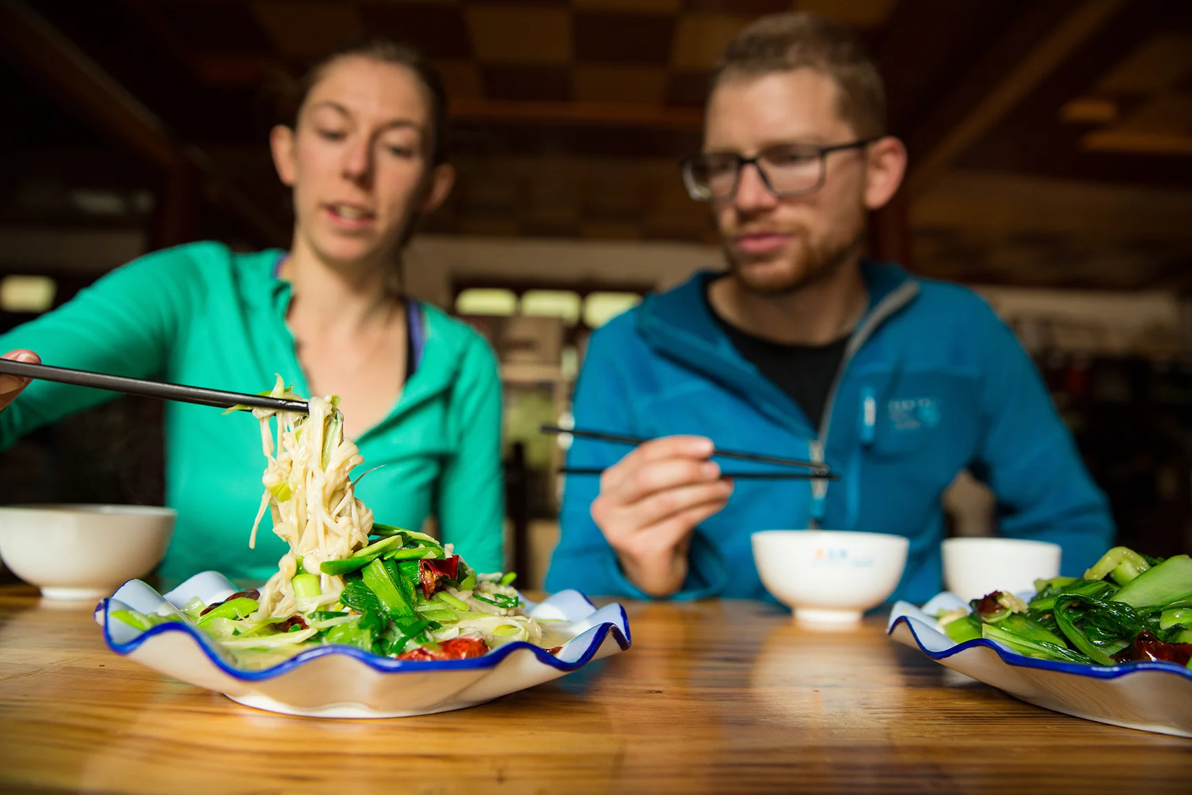 Danny Parker and Ashley Cracroft dig into a local mushroom and chives dish in Liming village © Irene Yee/Lady Lockoff Photography
