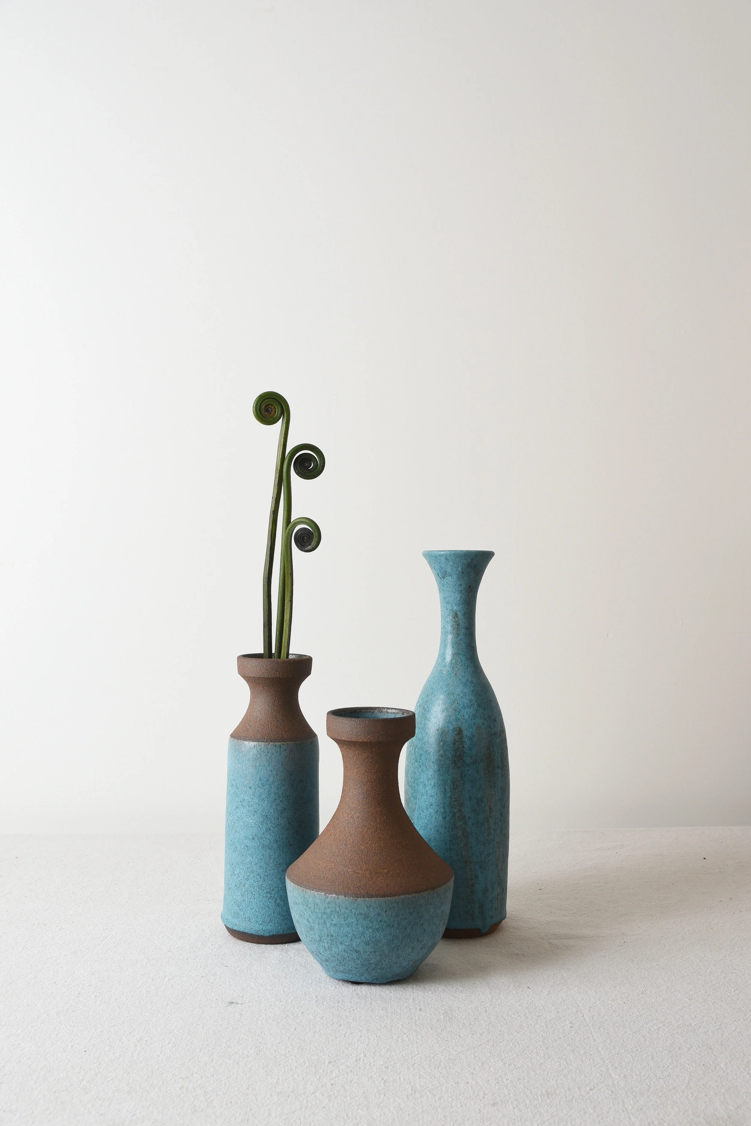 TURQUOISE AND RAW CLAY VASES