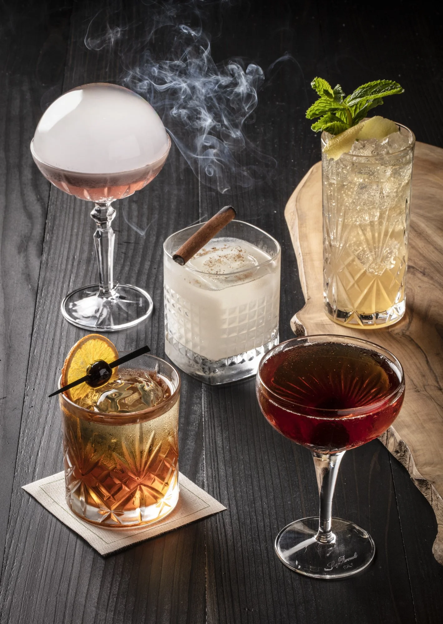 craft-cocktail-lineup-smoking-coupe-dark-wood.jpg