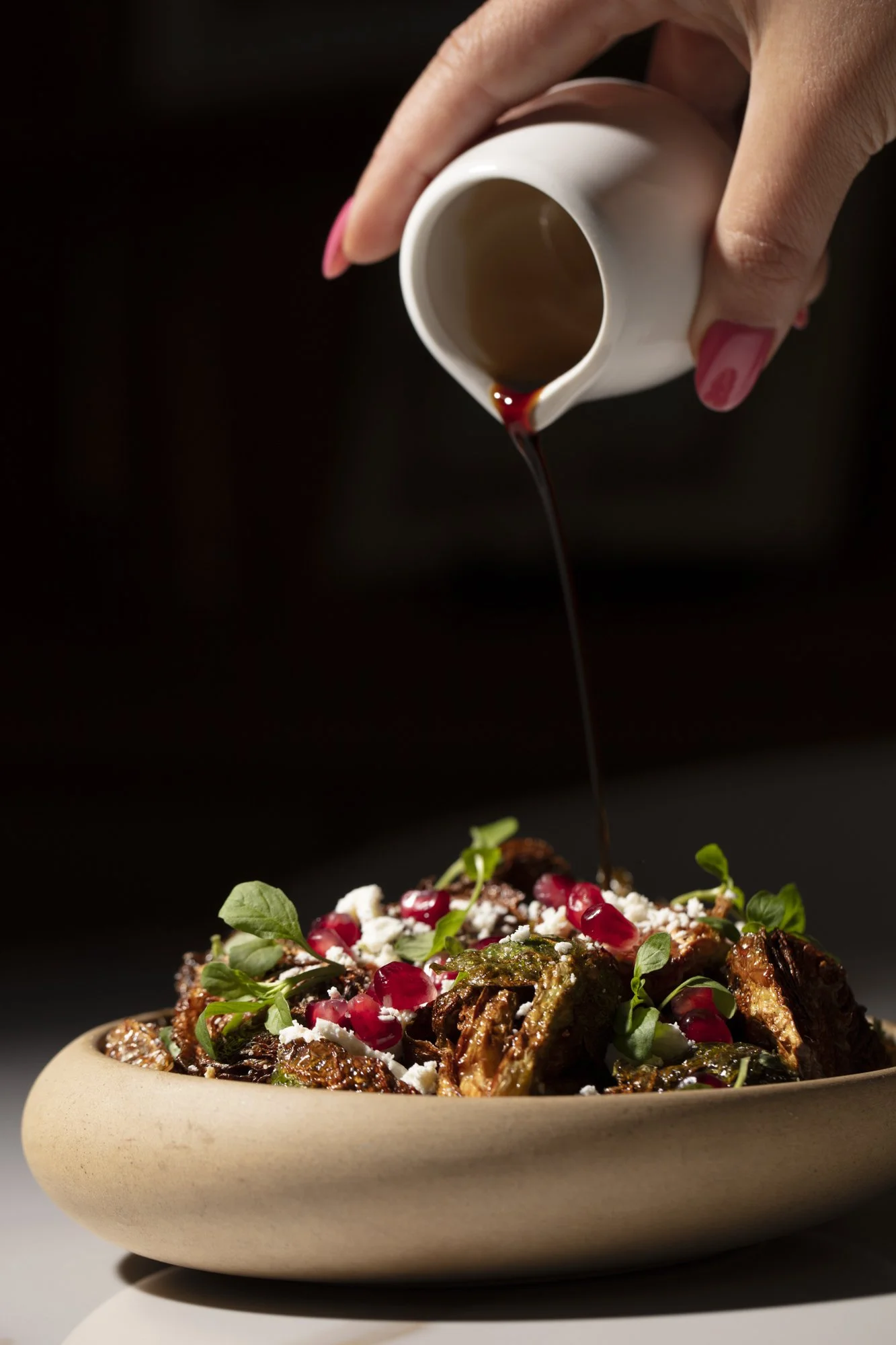 pouring-pomegranate-molasses-over-salad.jpg