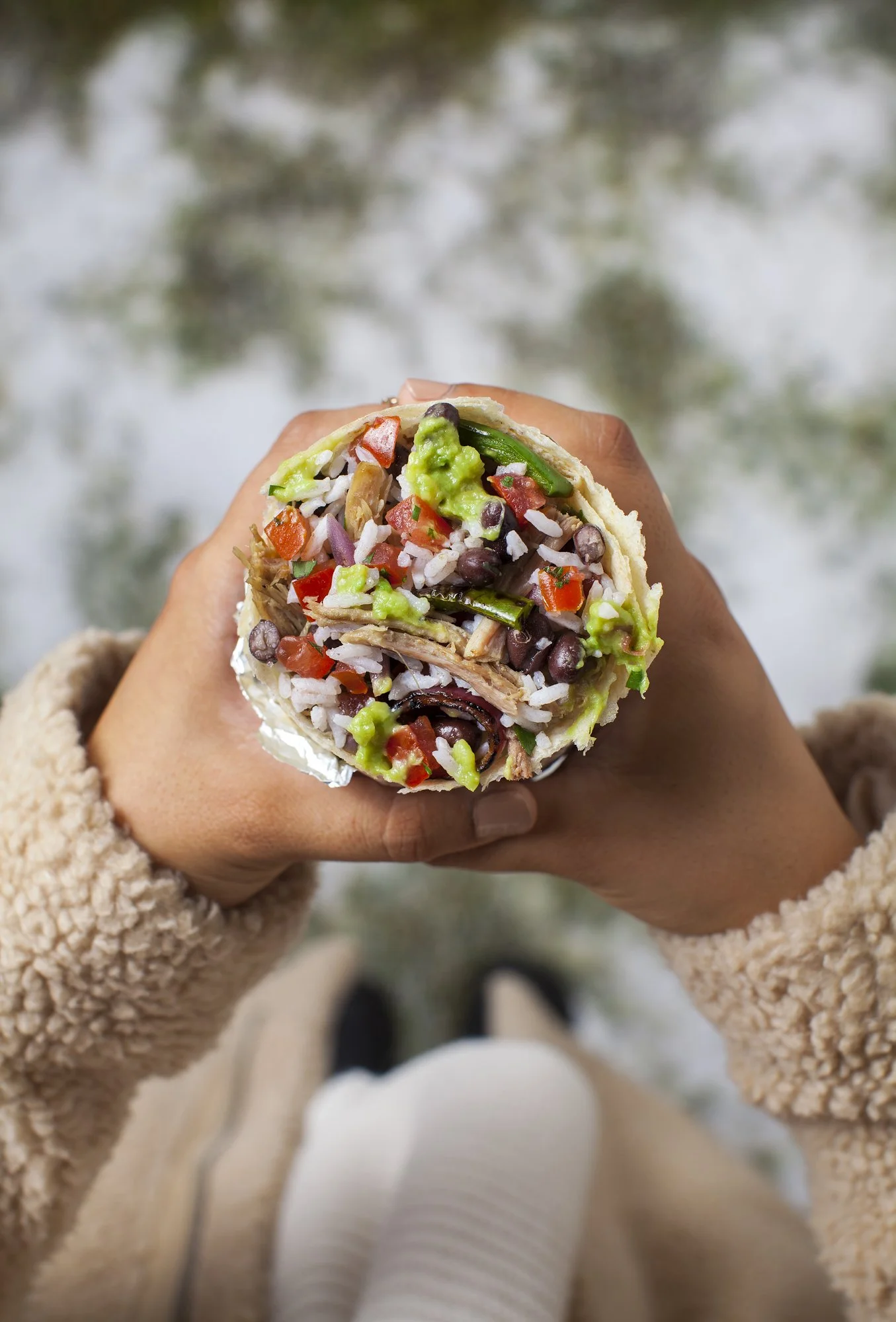 Hands holding a burrito, hand model food photography for restaurants in Los Angeles