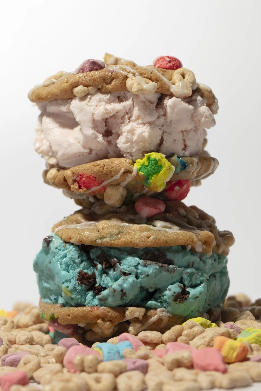 Stack of three cookies with colored ice cream and candies, on sprinkles. San Diego food photographer and stylist 