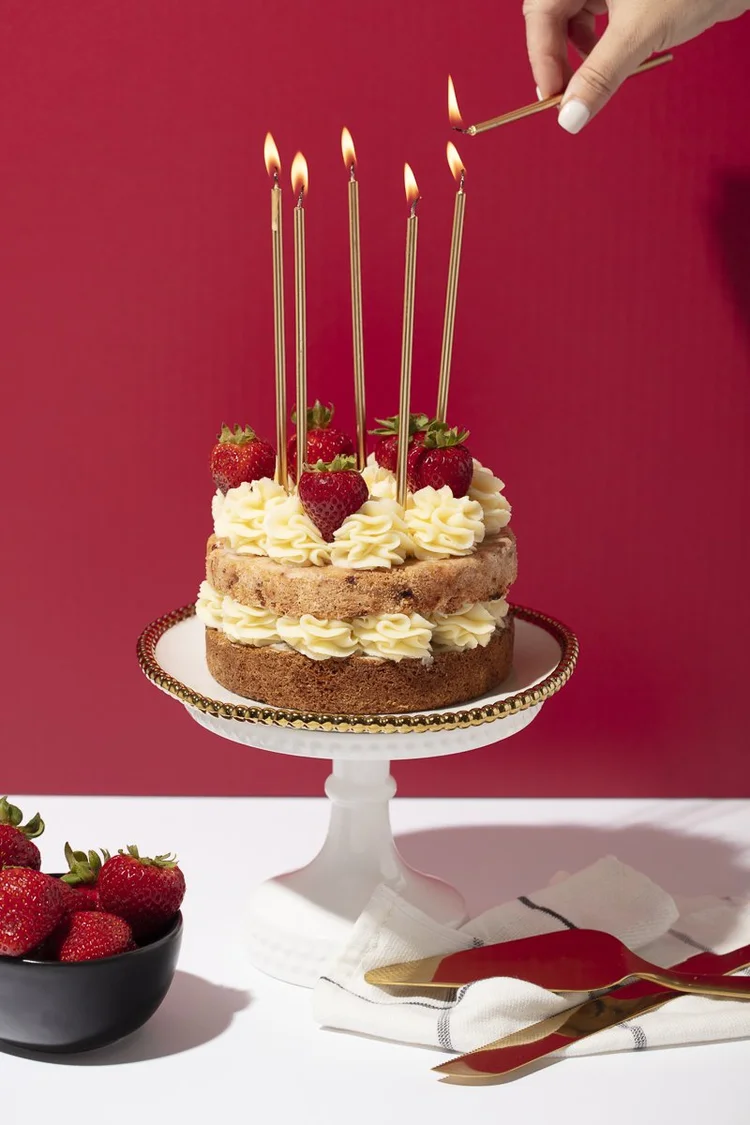 Birthday cake with candles on a red background - high key food photography, San Diego