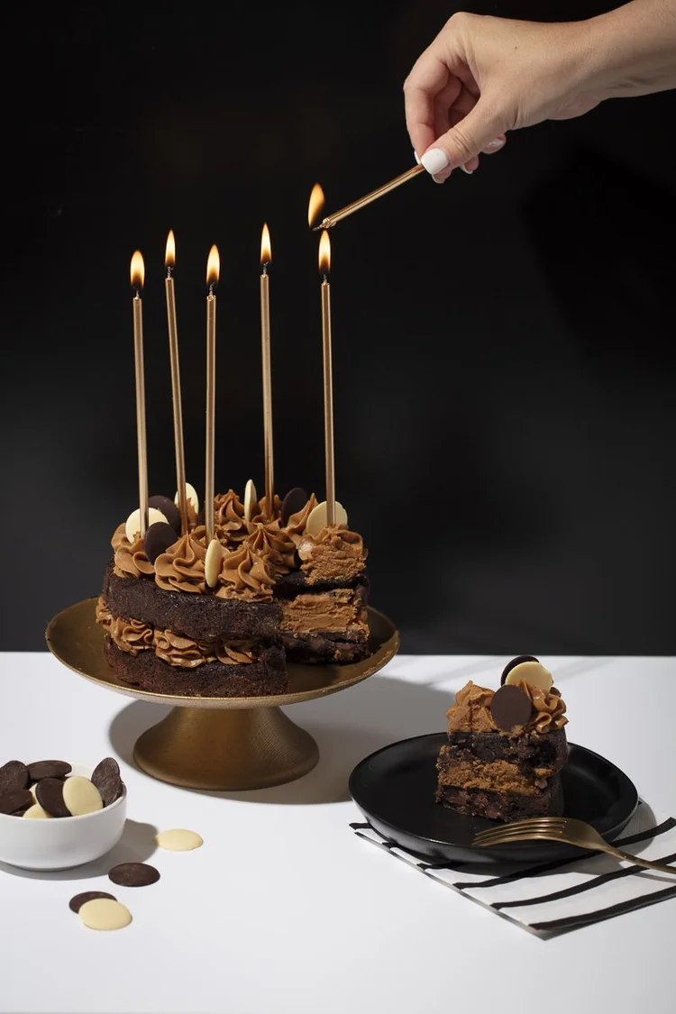 Chocolate birthday cake on a black background - moody dessert photography