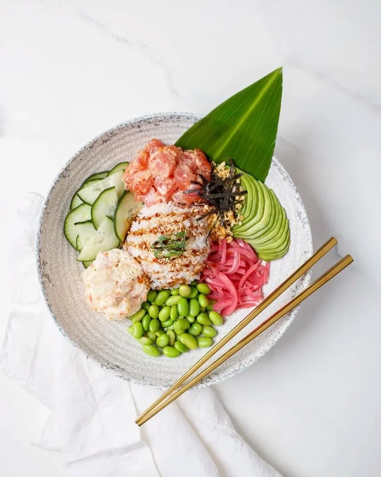 Poke bowl with cucumber, avocado and chopsticks - soft diffused food photography