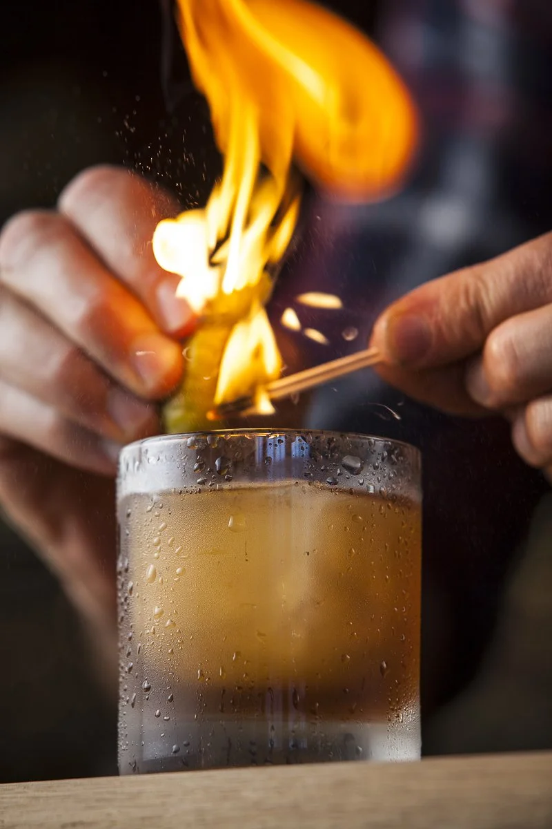 Old fashioned cocktail being lit, beverage photographer
