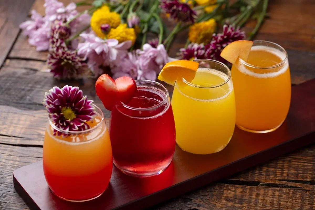 Flight of colorful cocktails garnished with fruit and flowers, beverage and cocktail photography in Orange County and Los Angeles