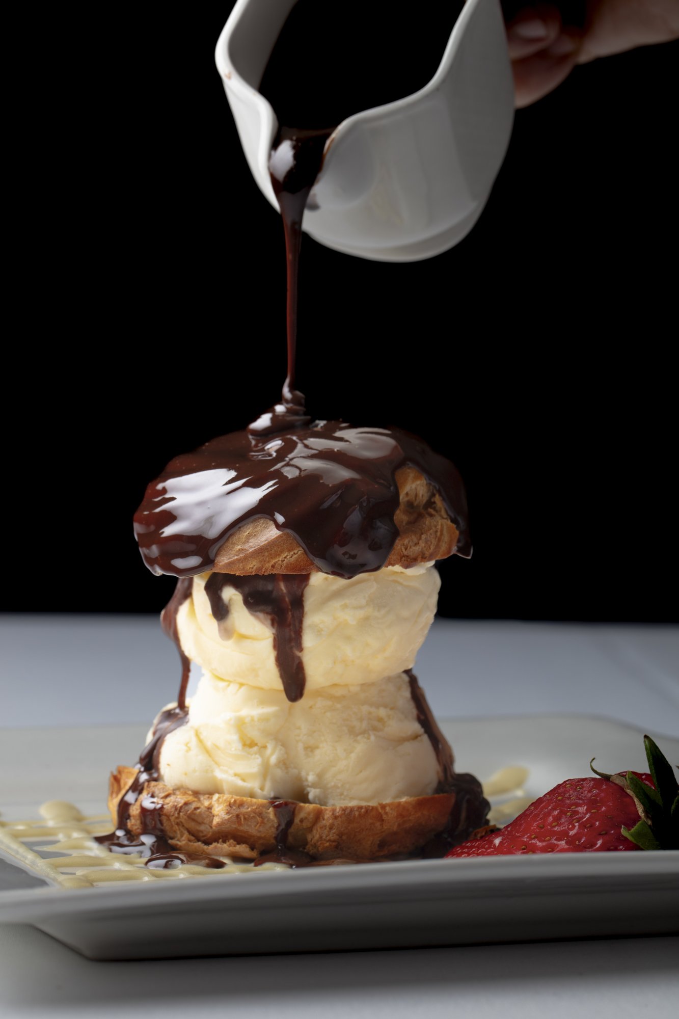 pouring-chocolate-over-profiterole-ice-cream.jpg