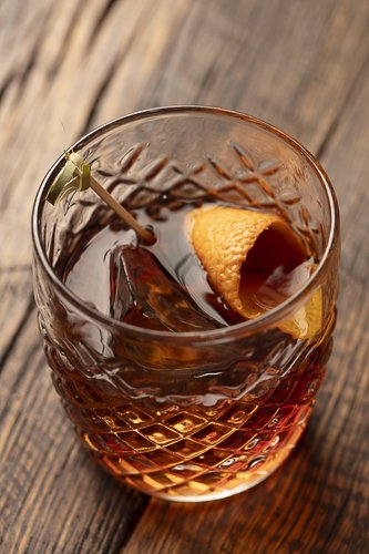 Old fashioned cocktail with orange peel in a crystal glass, restaurant bar and beverage photographer, Orange County