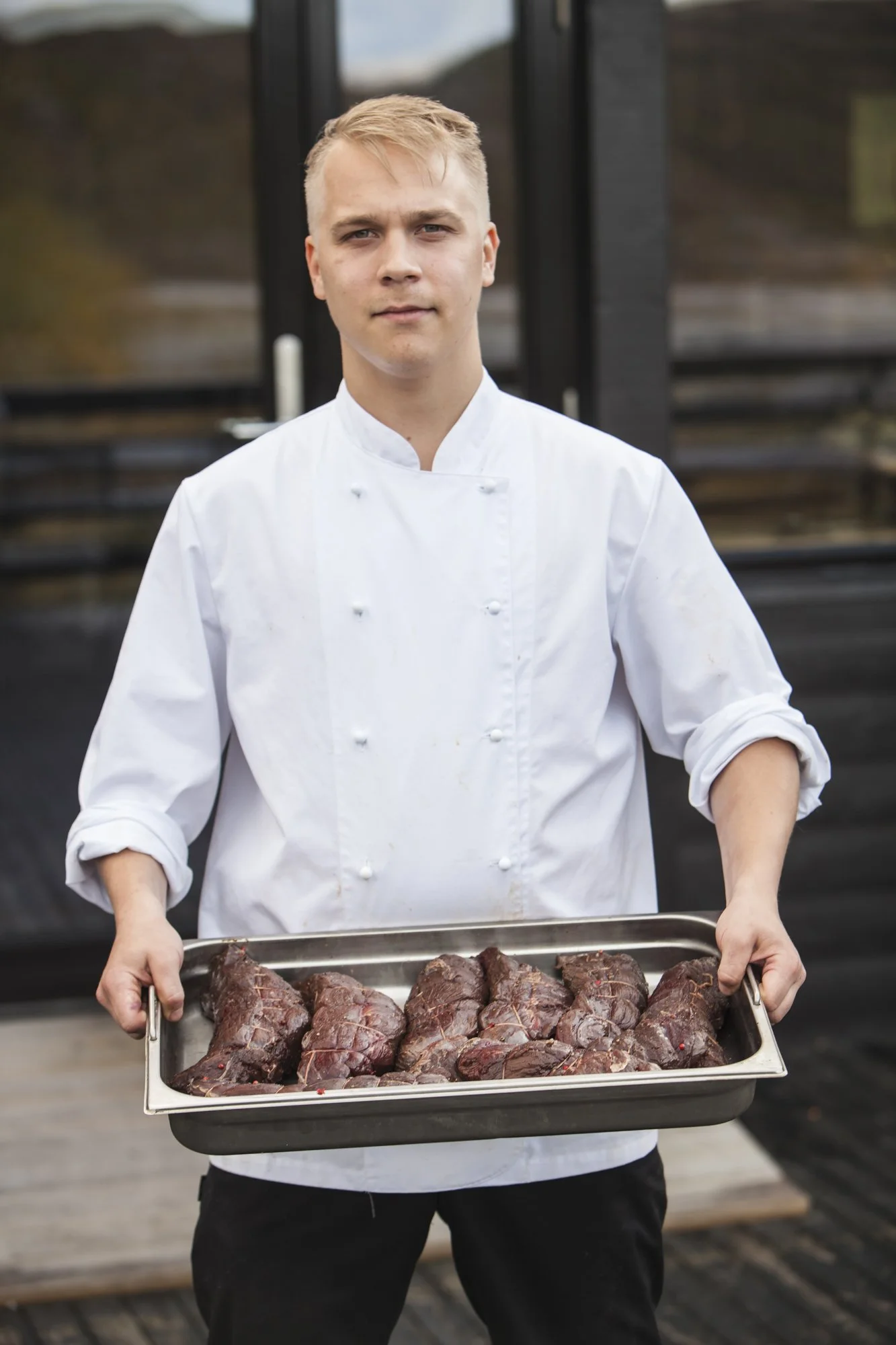 chef-portrait-holding-tray-of-meat.jpg