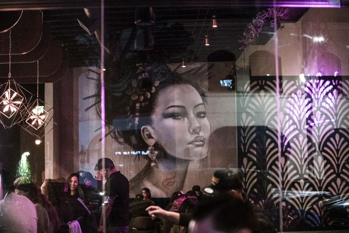 Restaurant dining room with mural and moody lighting, restaurant interior photography, Orange County