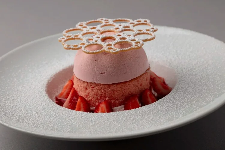 Plated strawberry mousse with a lace tuile - soft light dessert photography