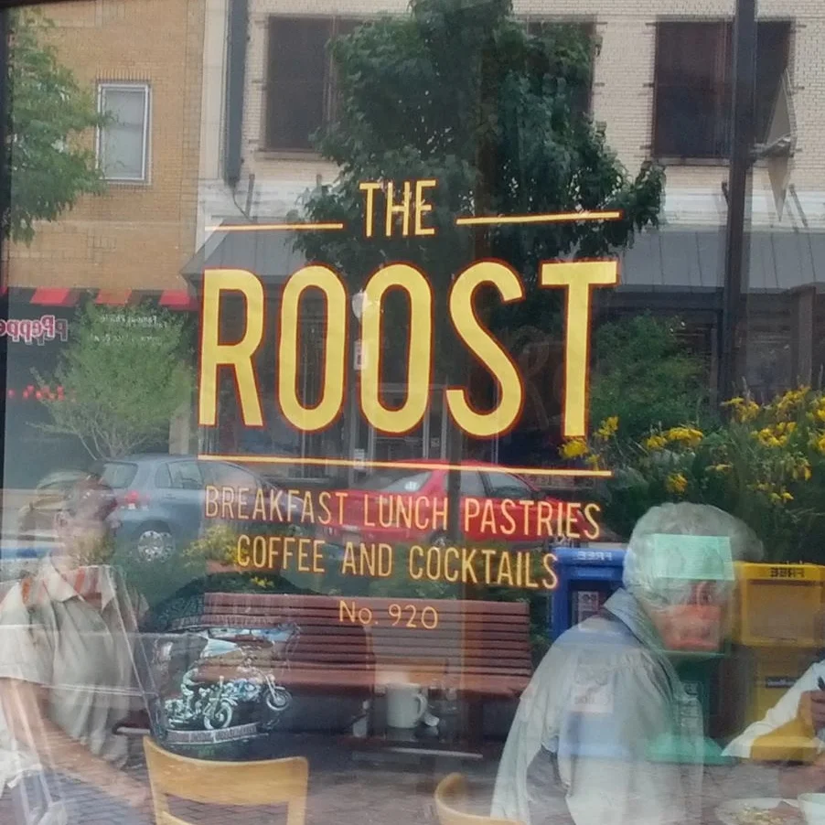 The Roost logo painted on the front window