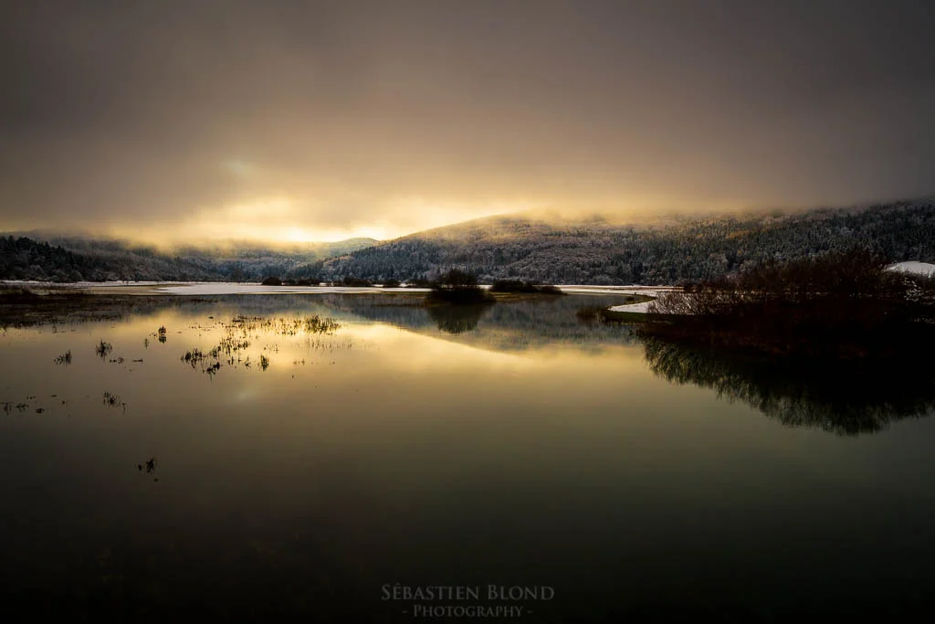 The light just beginning to come through the low clouds over Lake Cerknica