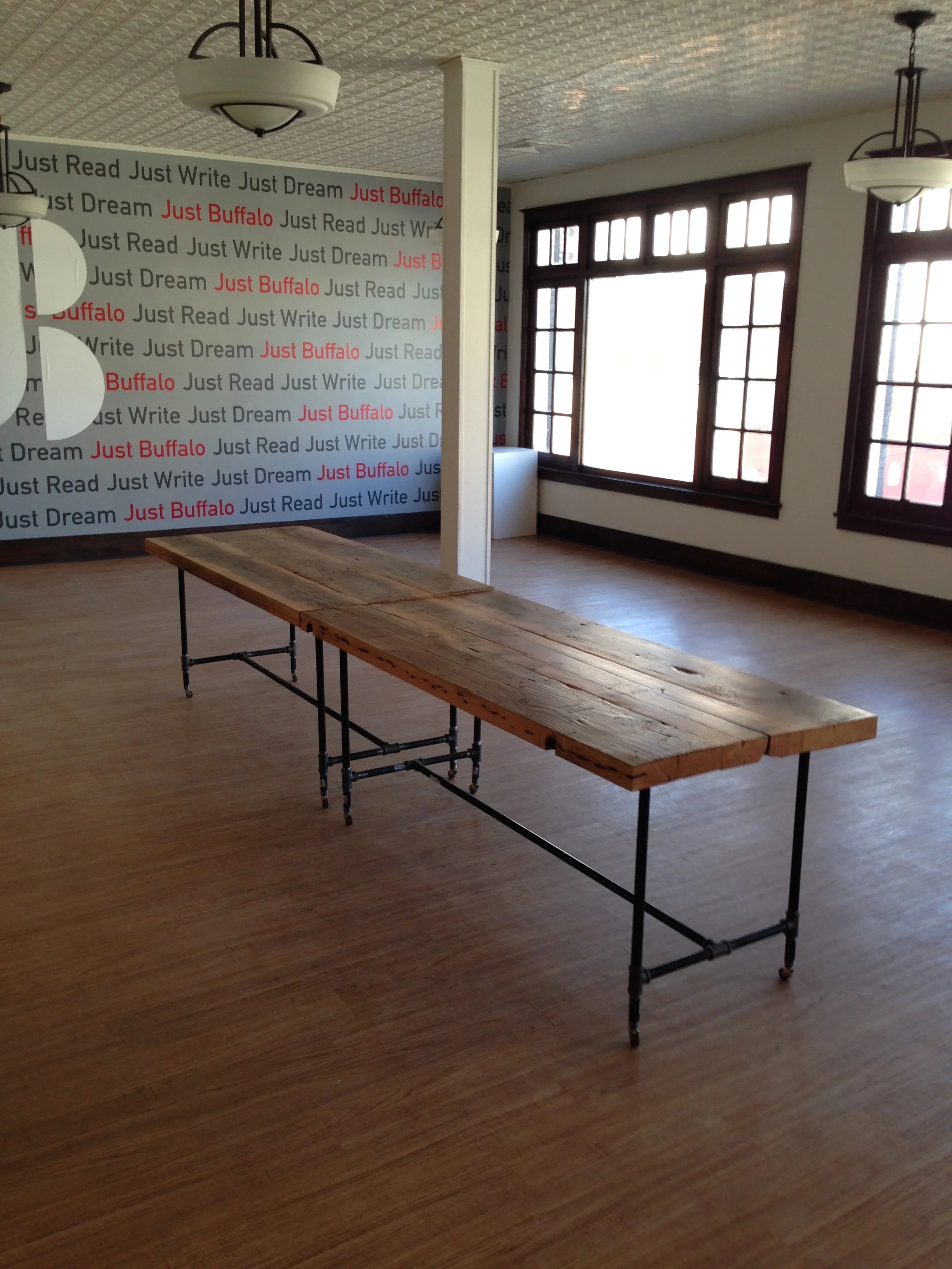 matching tables for Just Buffalo Litterary Center - black pipe legs with wooden casters for fluidity to adapt to any space