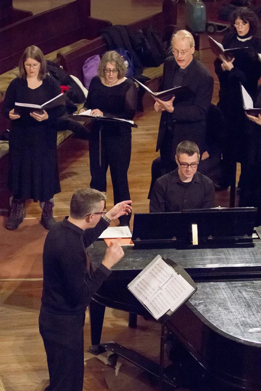Choral Soloists Brenda DeCommer, Olivia Sohmer Rosenbaum, and Paul Lockhart in lively Hocket mode ... led by Music Director Jason Asbury with Accompanist Matthew Henning playing silent piano.