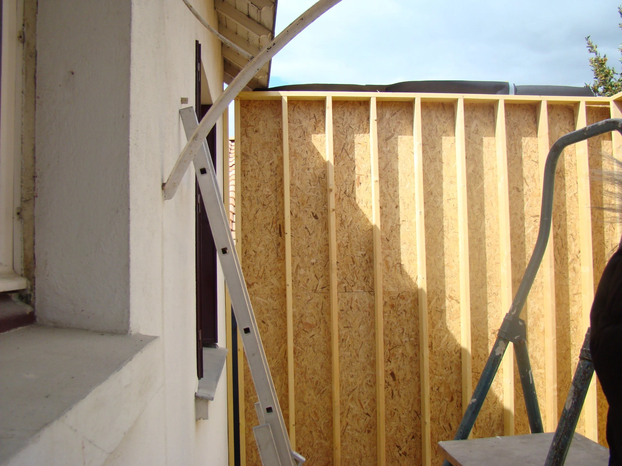 Chantier de l'extension ACAJOU à Nantes : montage de l'ossature bois et du contreventement contre la maison existante