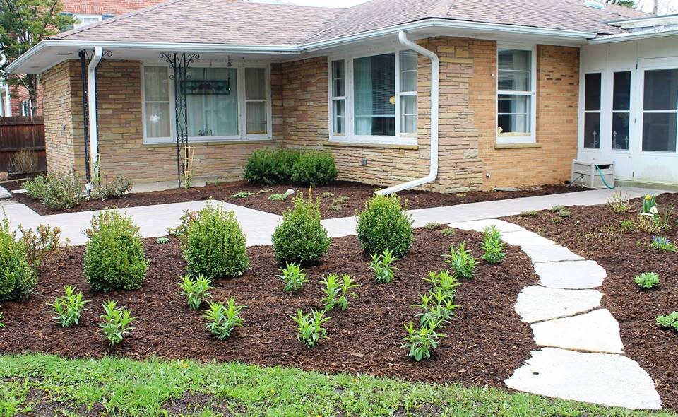 flagstones to new front wak and new plantings.jpg