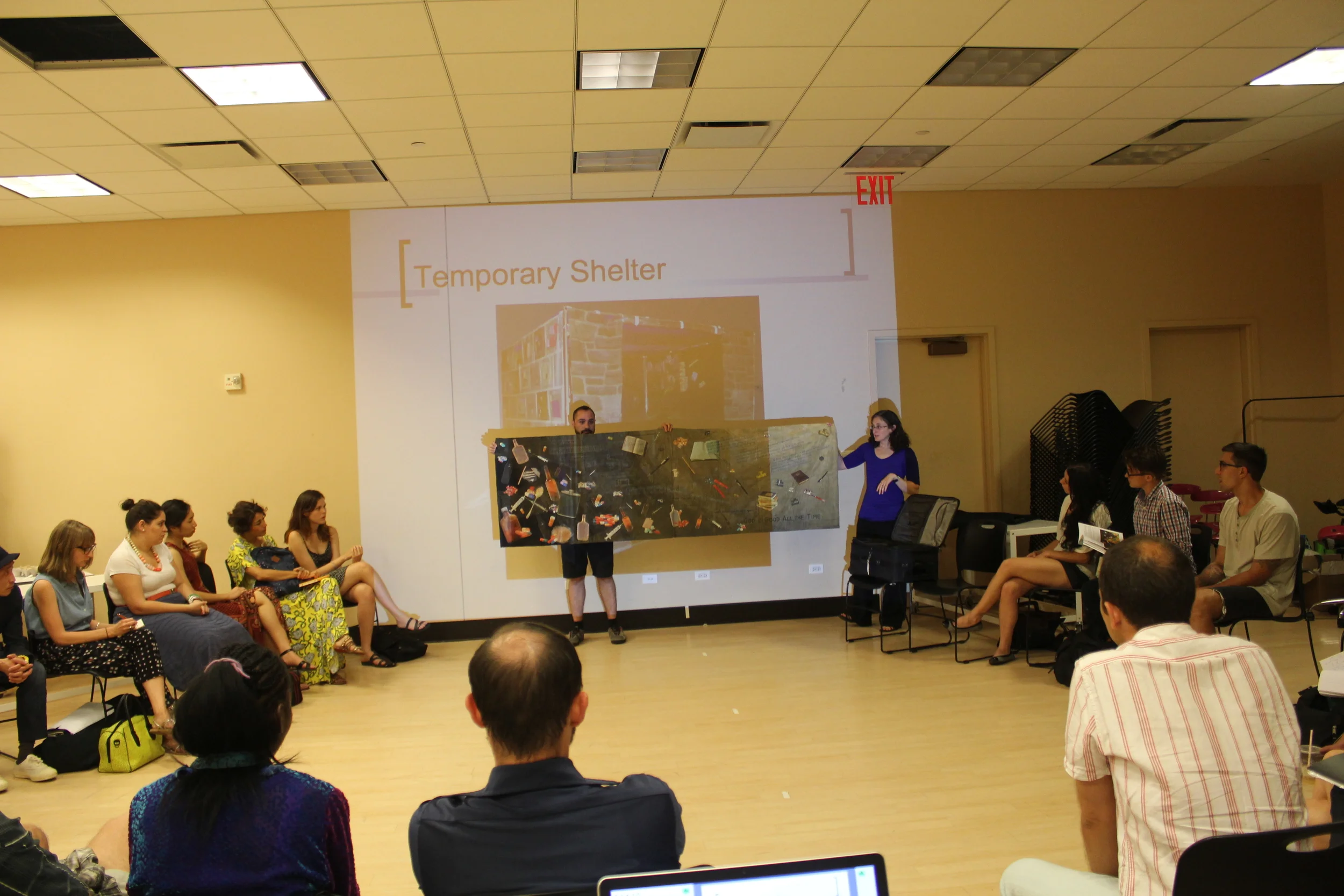 Artist Heather Stolz presents her artwork to the residents that was created from collaborations with homeless participants 