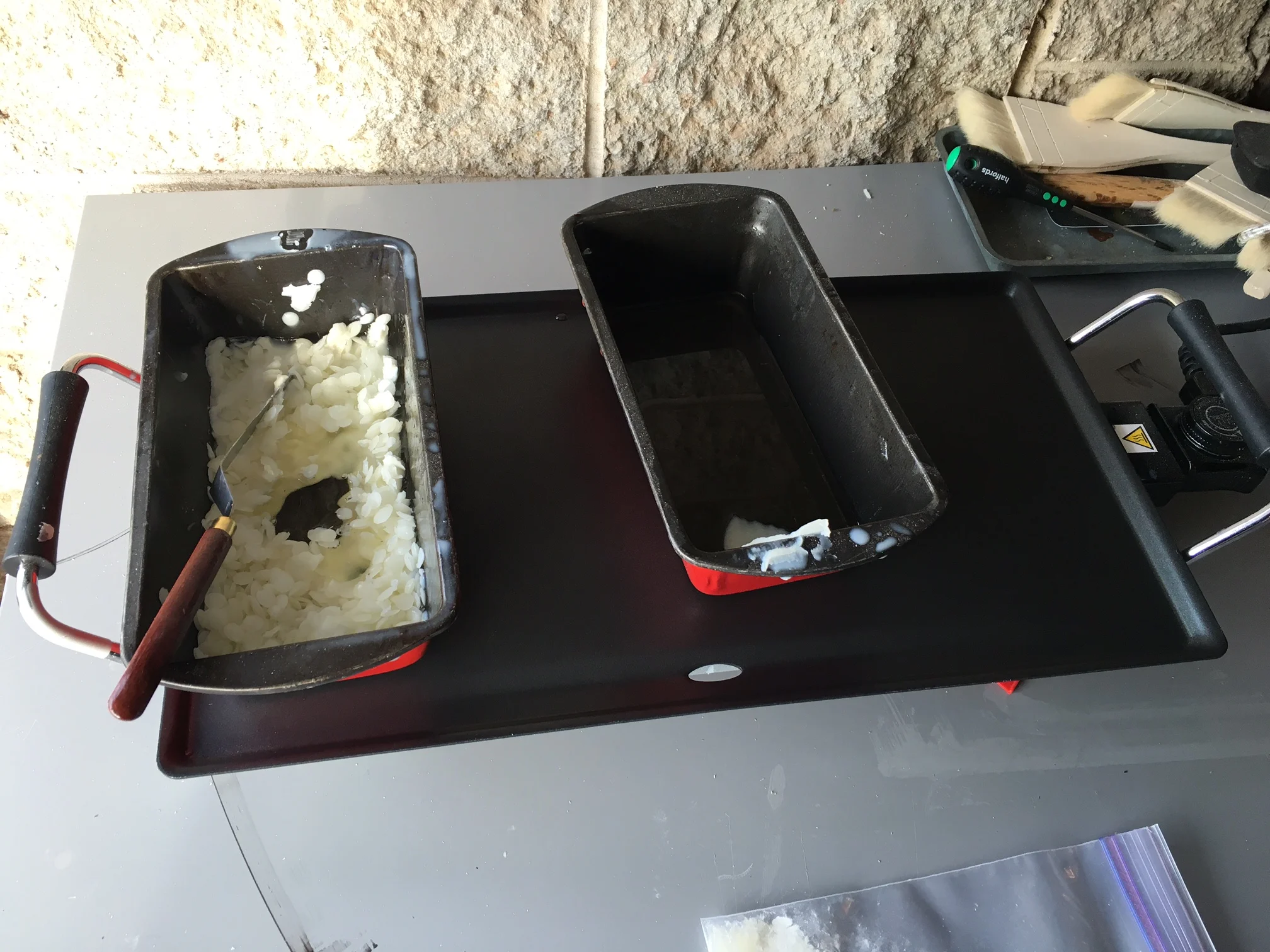 Preparing the beeswax and Damar resin for application on the hotplate.
