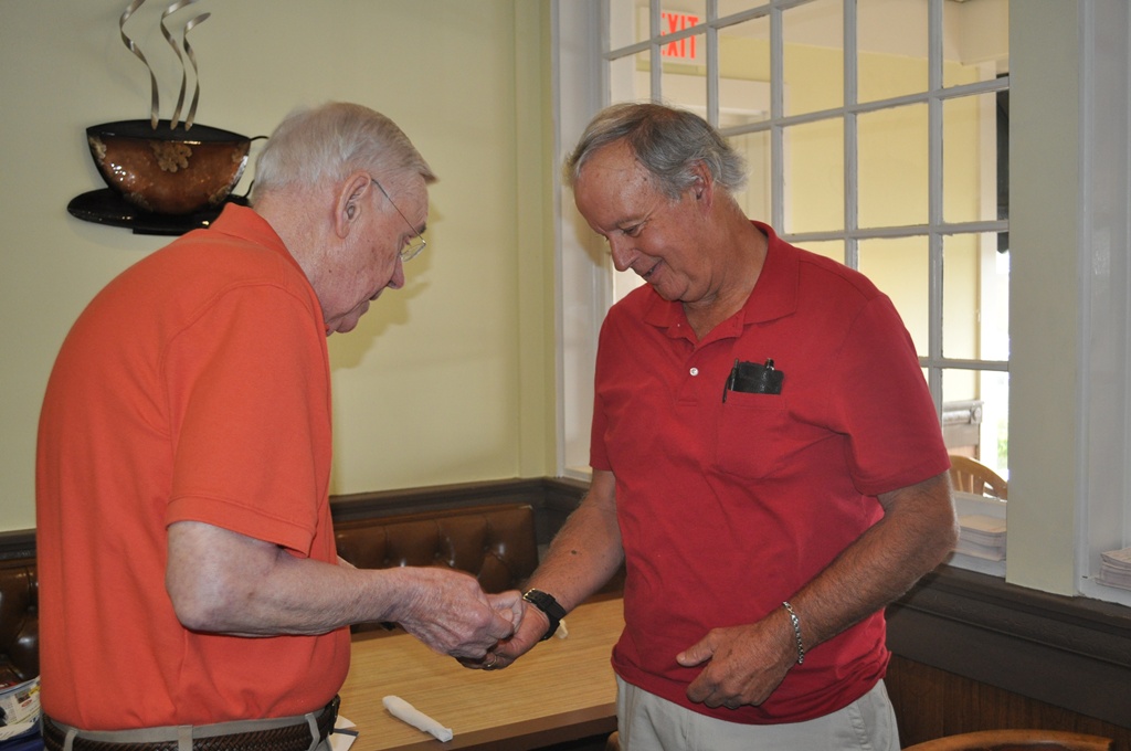 Lion Brad gives Lion Arnie his pin