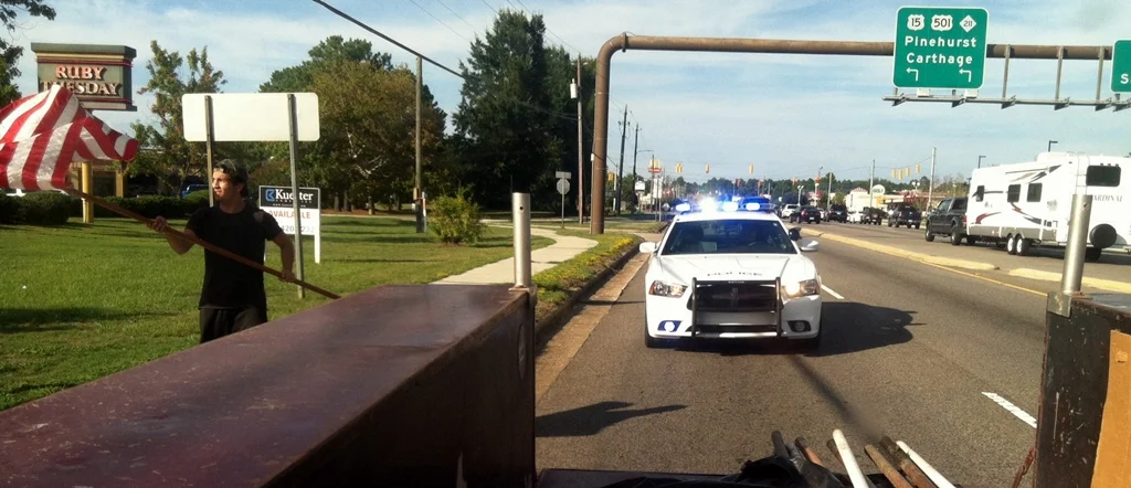  Jason Callaham, son of Lion Mike, helps the Aberdeen Lions to pick up flags along Hwy US 1 in Aberdeen. 