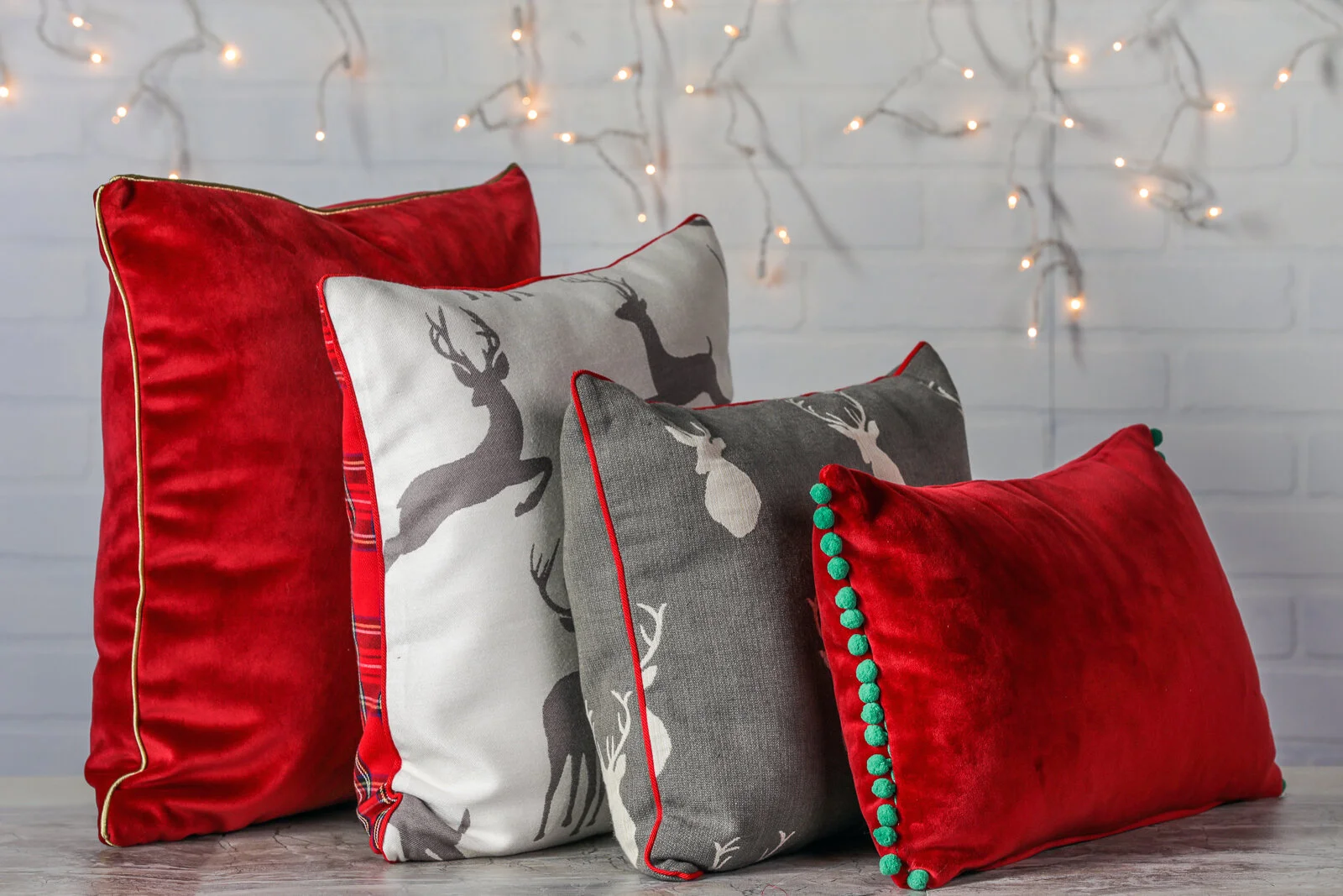 Red Velvety Pillow with Green Pom Poms