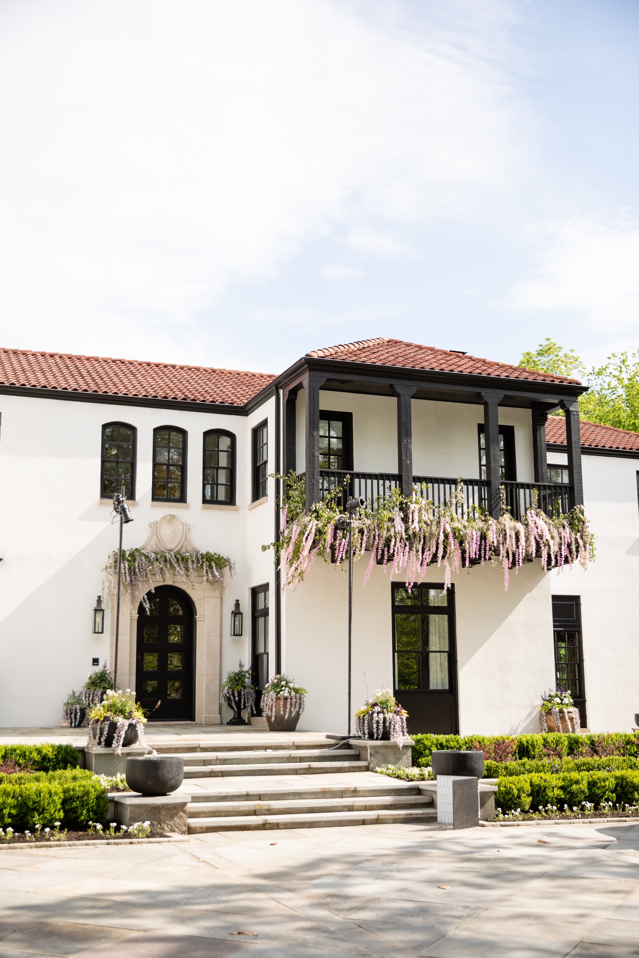Bridgerton inspired engagement party at a private home in Nashville, TN with lush, organic floral installations of wisteria, spanish moss, and pastel blooms