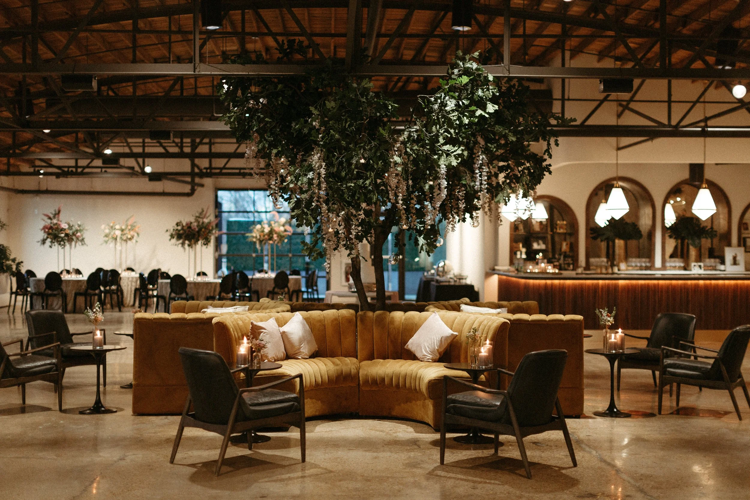 Stunning floral installations bring warmth to this Great Gatsby inspired wedding with florals of terra cotta, dusty pink, and burgundy hues. Petal heavy roses, wisteria, copper beech, and pink pampas grass accents. Designed by Rosemary and Finch in N