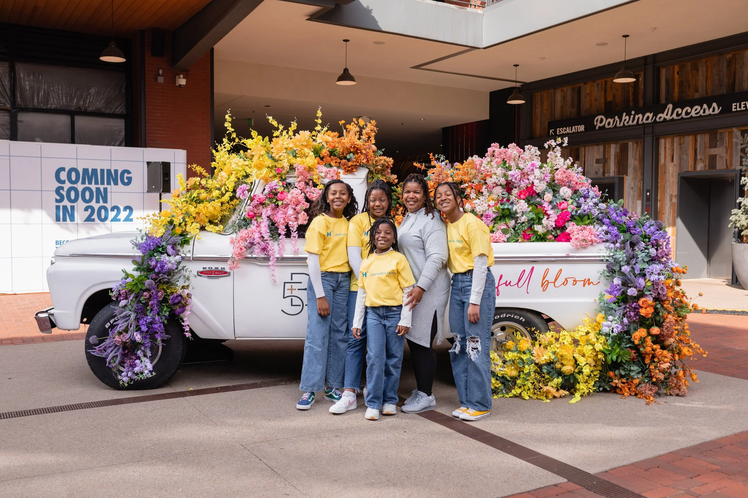 Cheerful pickup truck installation composed of silk floral hues in pink, magenta, lavender, coral, orange, yellow, and mixed greens bring to life this spring Fifth + Broadway event in Nashville, TN. Design by Rosemary and Finch.