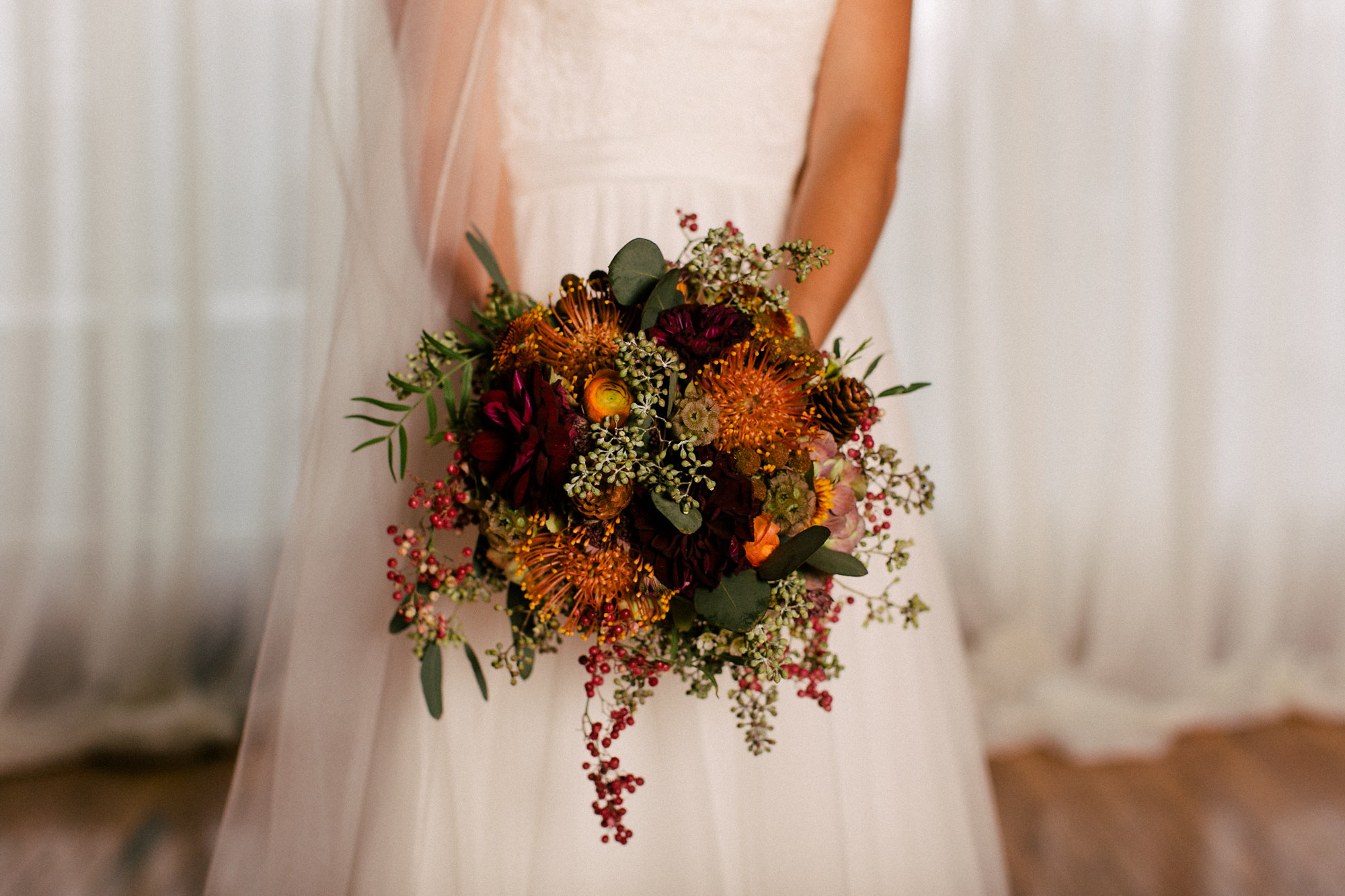 Fall bridal bouquet with pincushion protea, dahlias, and pinecones // Nashville Wedding Florist