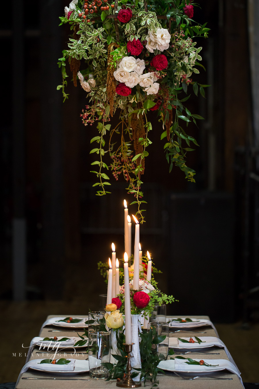 Head table with hanging arrangement, candles, and garland // Nashville Wedding Florist