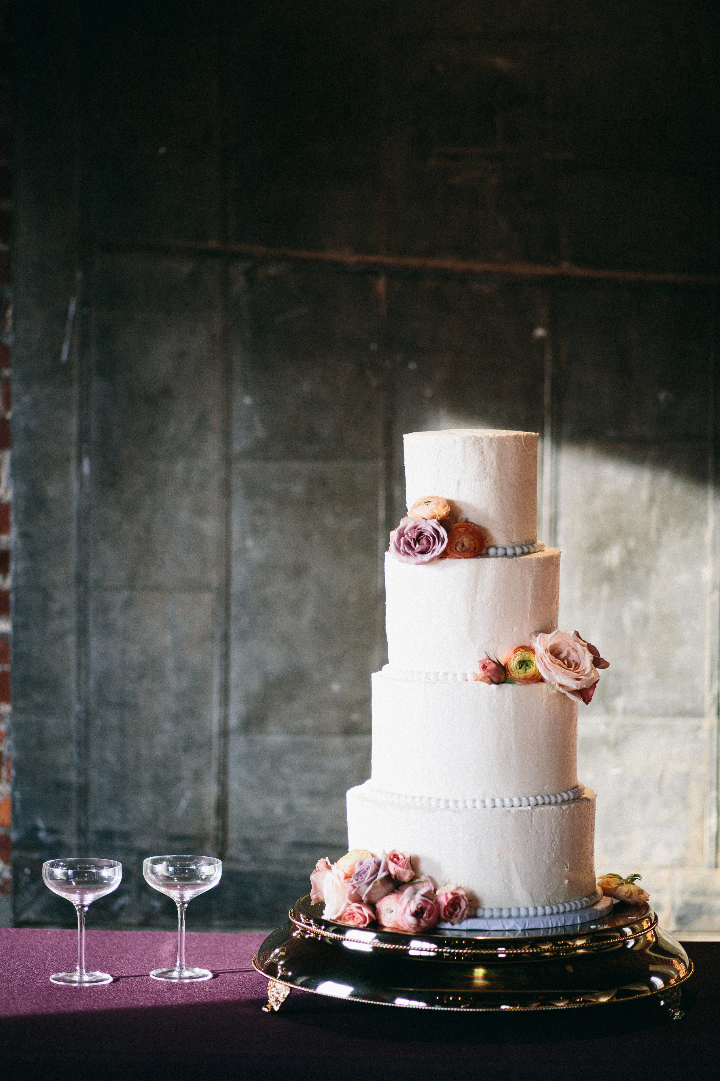 Wedding cake with floral accents // Mauve and coral wedding flowers // Nashville Floral Design