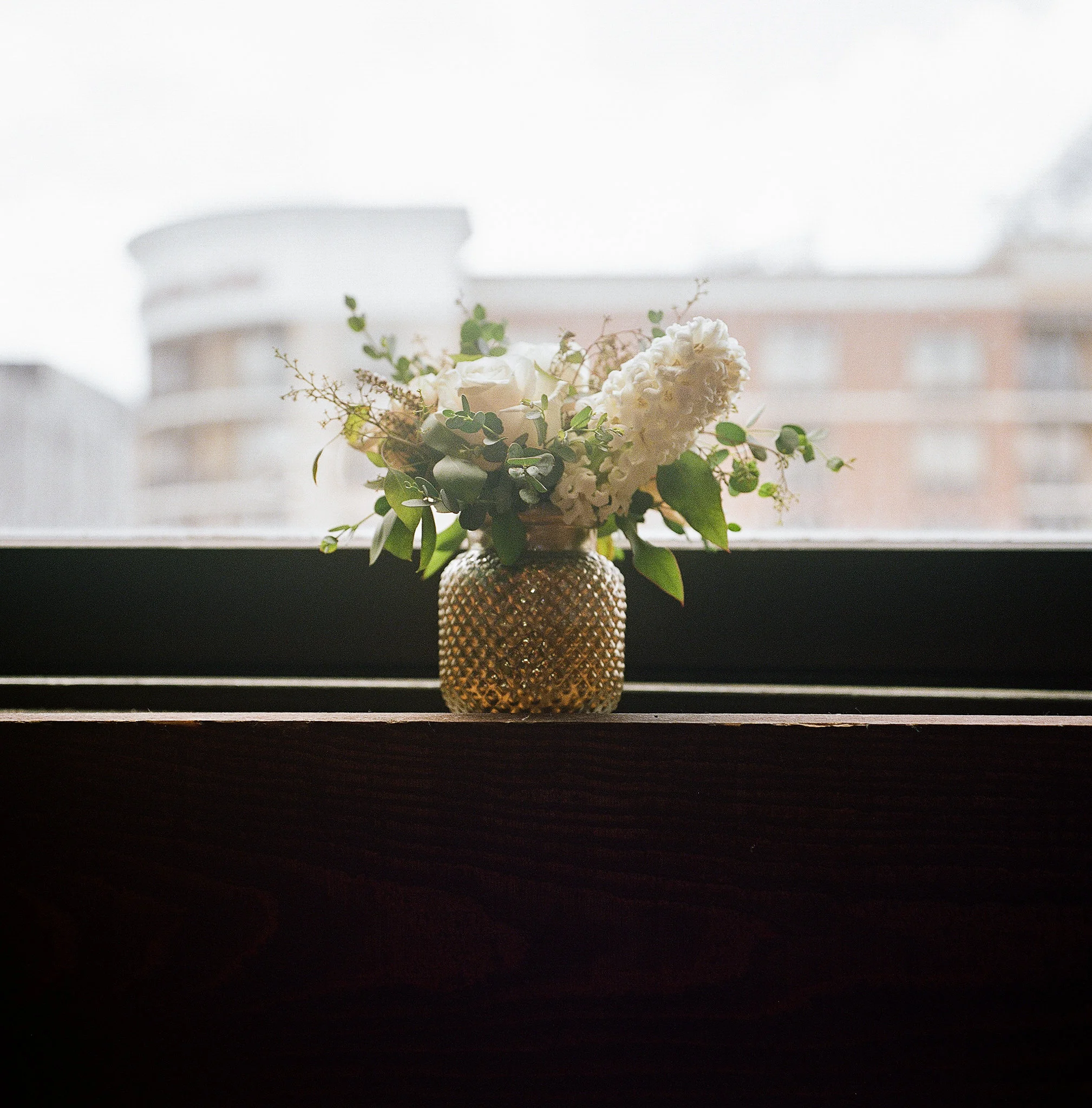 Gold mercury glass vases with blush and neutral flowers