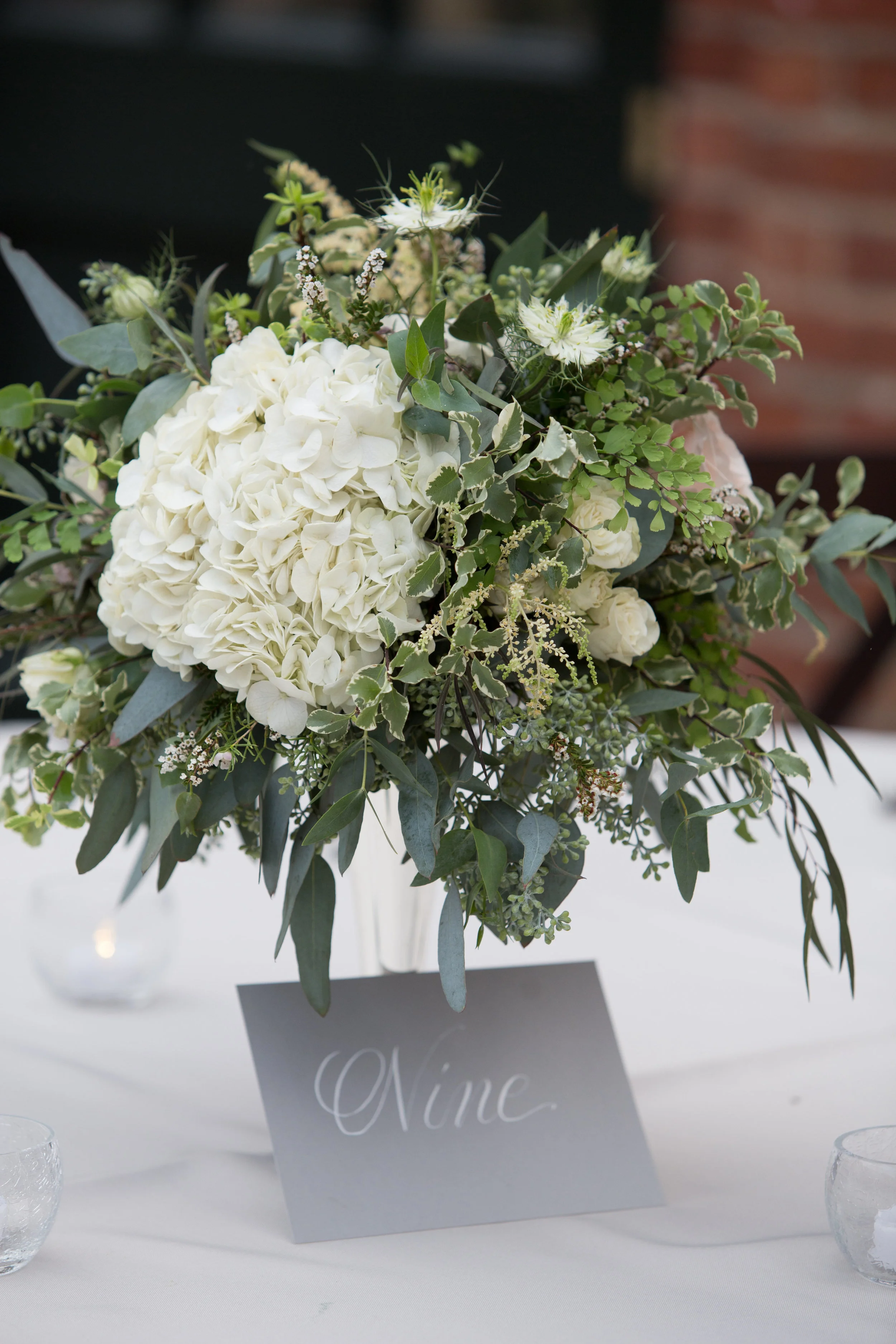 Hydrangea, garden roses, and organic greenery centerpiece