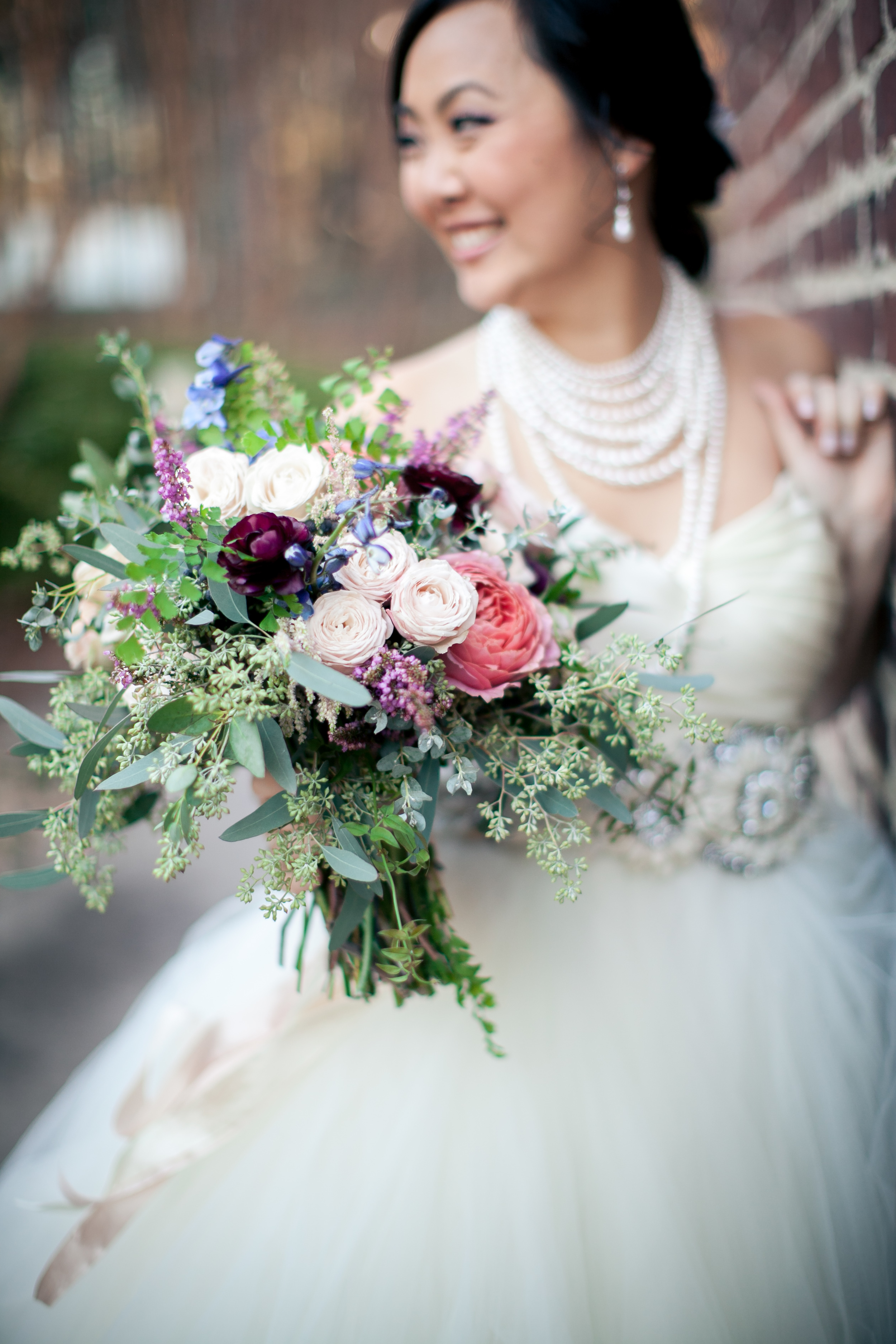 Romantic tulle wedding dress paired with organic, trailing bouquet