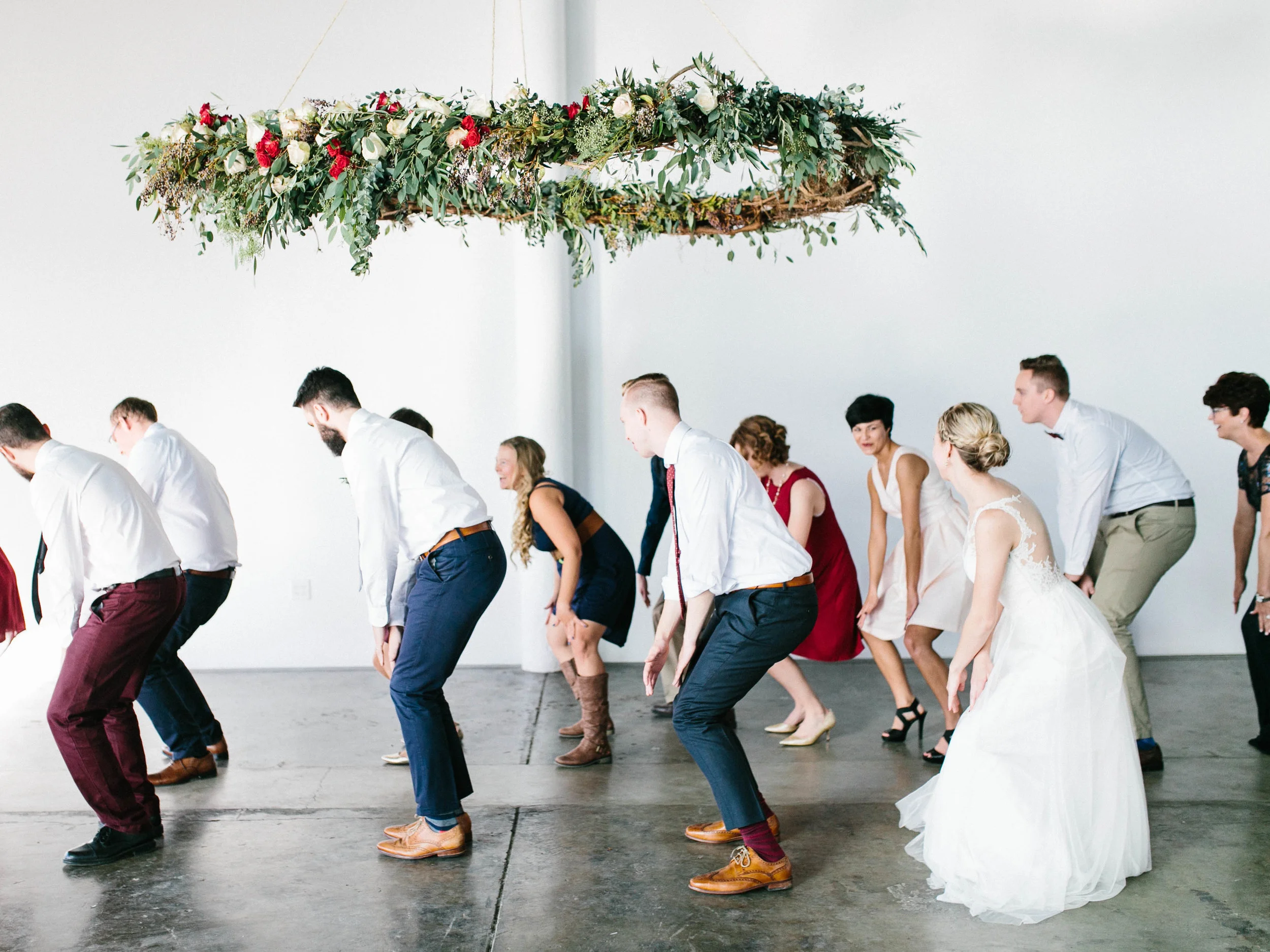 Dancing under a suspended floral arrangement // Destination Wedding Florist