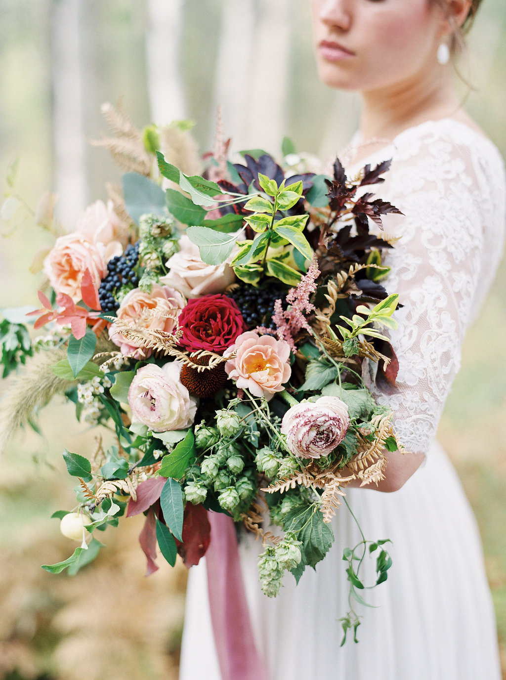 Trailing bridal bouquet with ranunculus, hops, and garden roses // Destination Florist