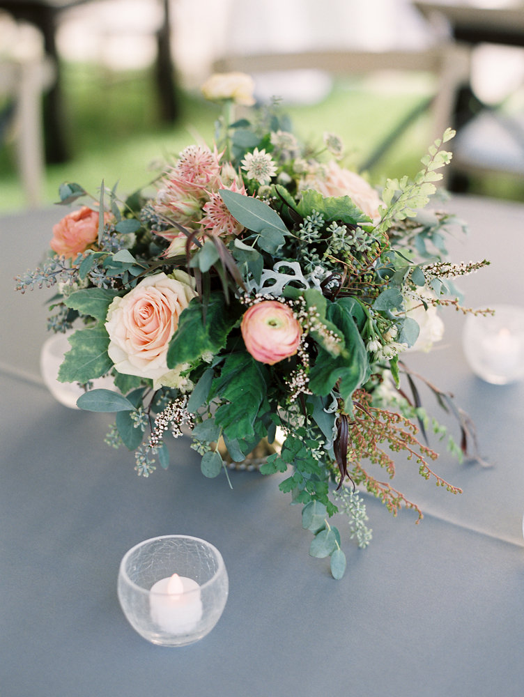 Lush centerpiece with peach and blush ranunculus // Nashville Upscale Wedding Floral Design