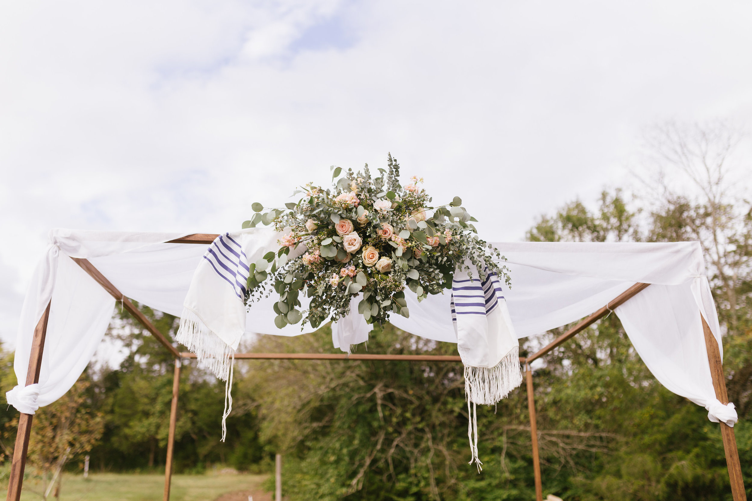 Traditional chuppah with loose floral spray // Nashville Wedding Florist