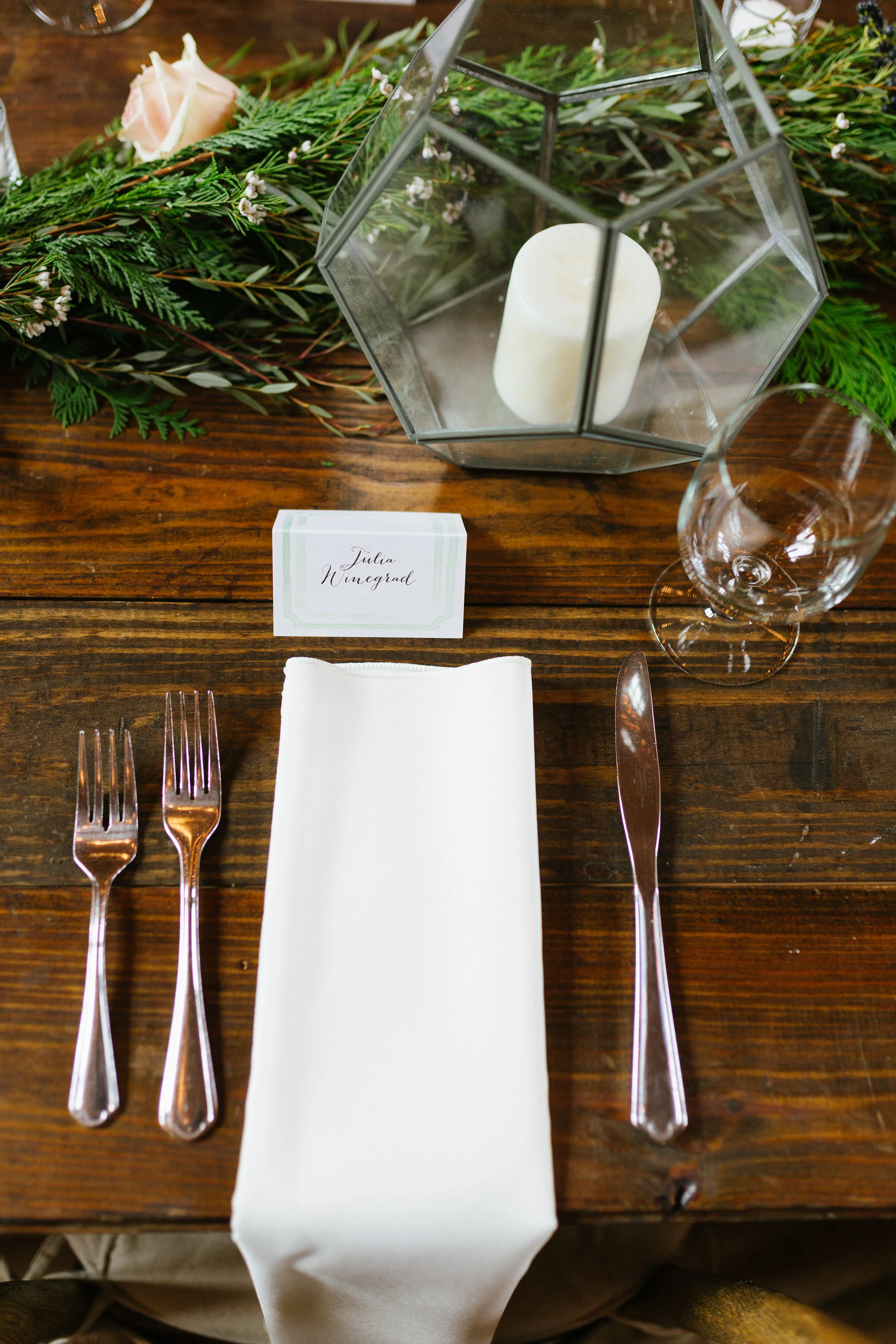 Greenery garland running down farm tables