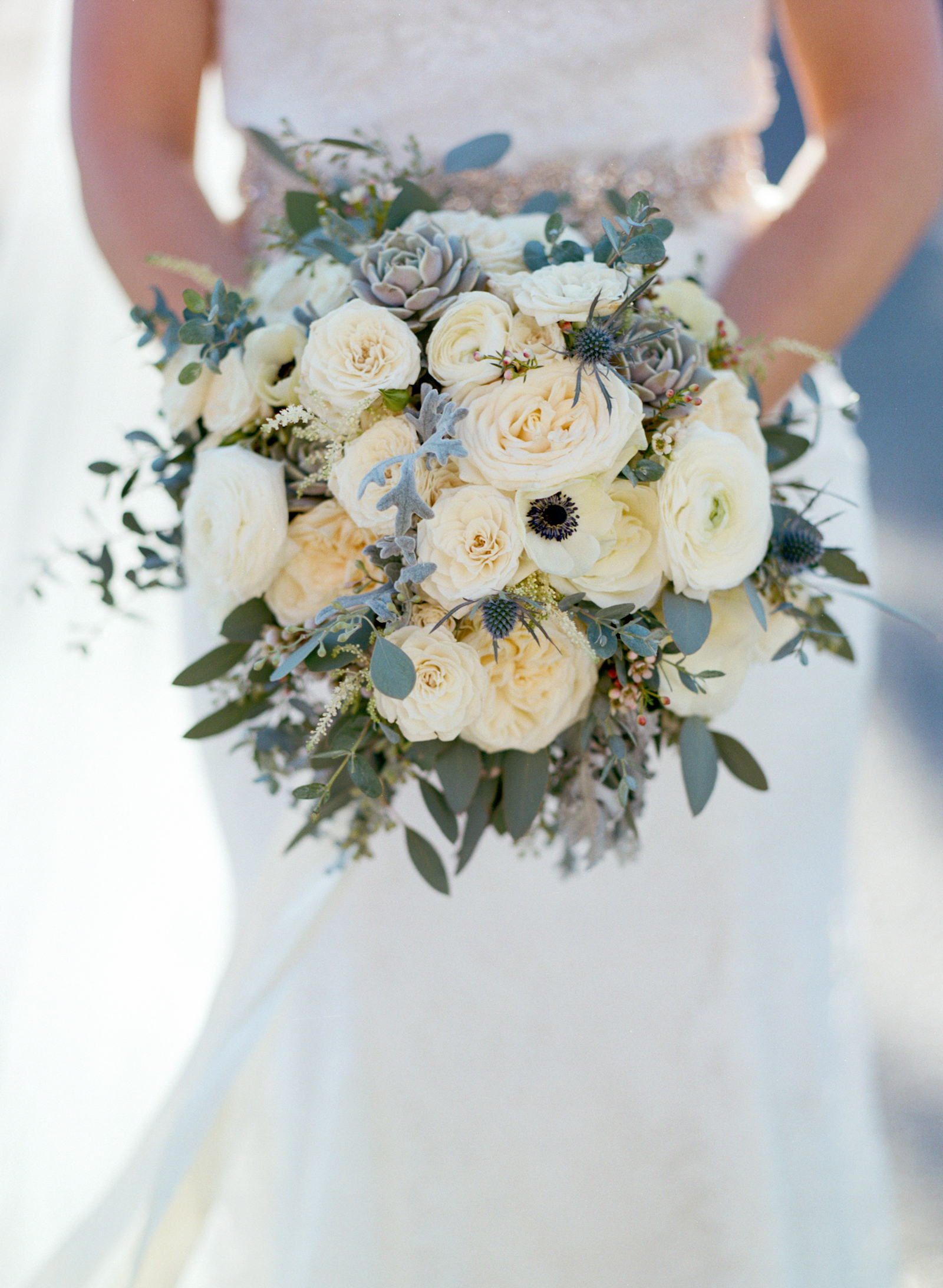 Lush bridal bouquet with all white flowers and anemones