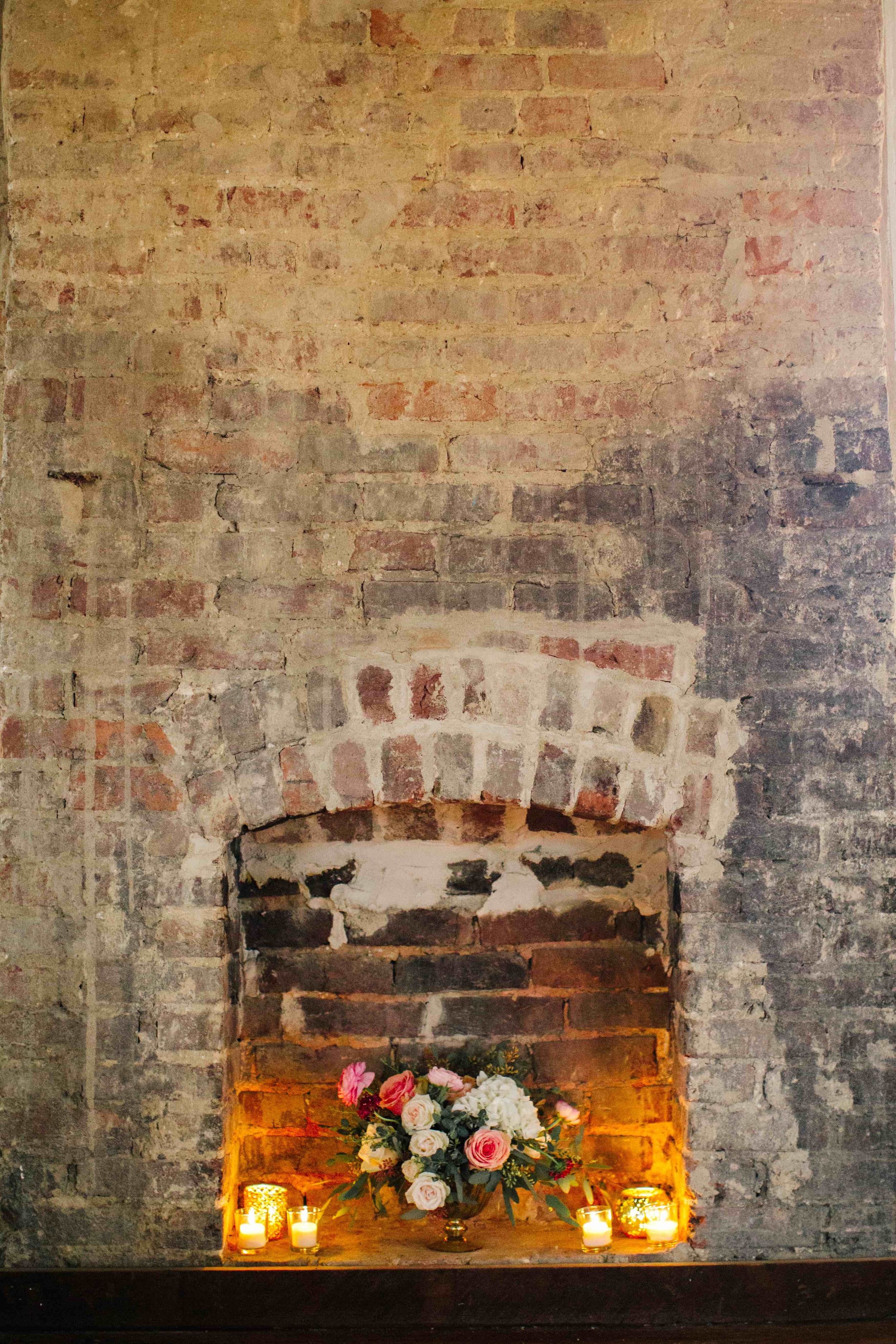 Floral arrangement in fireplace with candles // Blush and neutral Nashville Wedding flowers