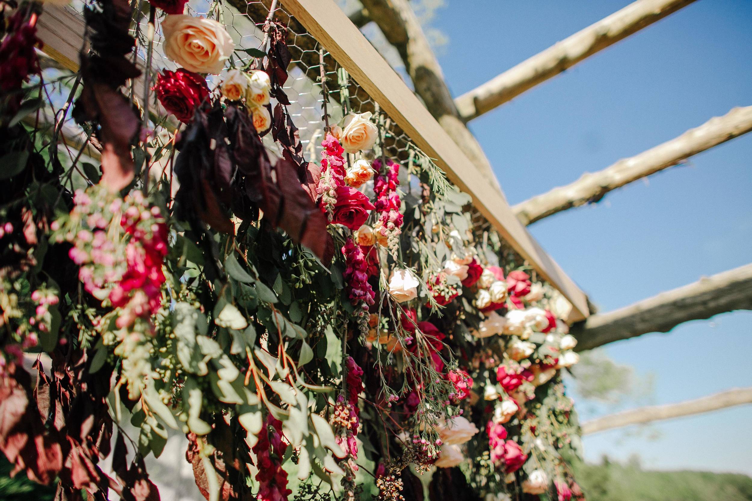Vibrant floral installation for wedding ceremony backdrop // Destination Wedding Floral Design