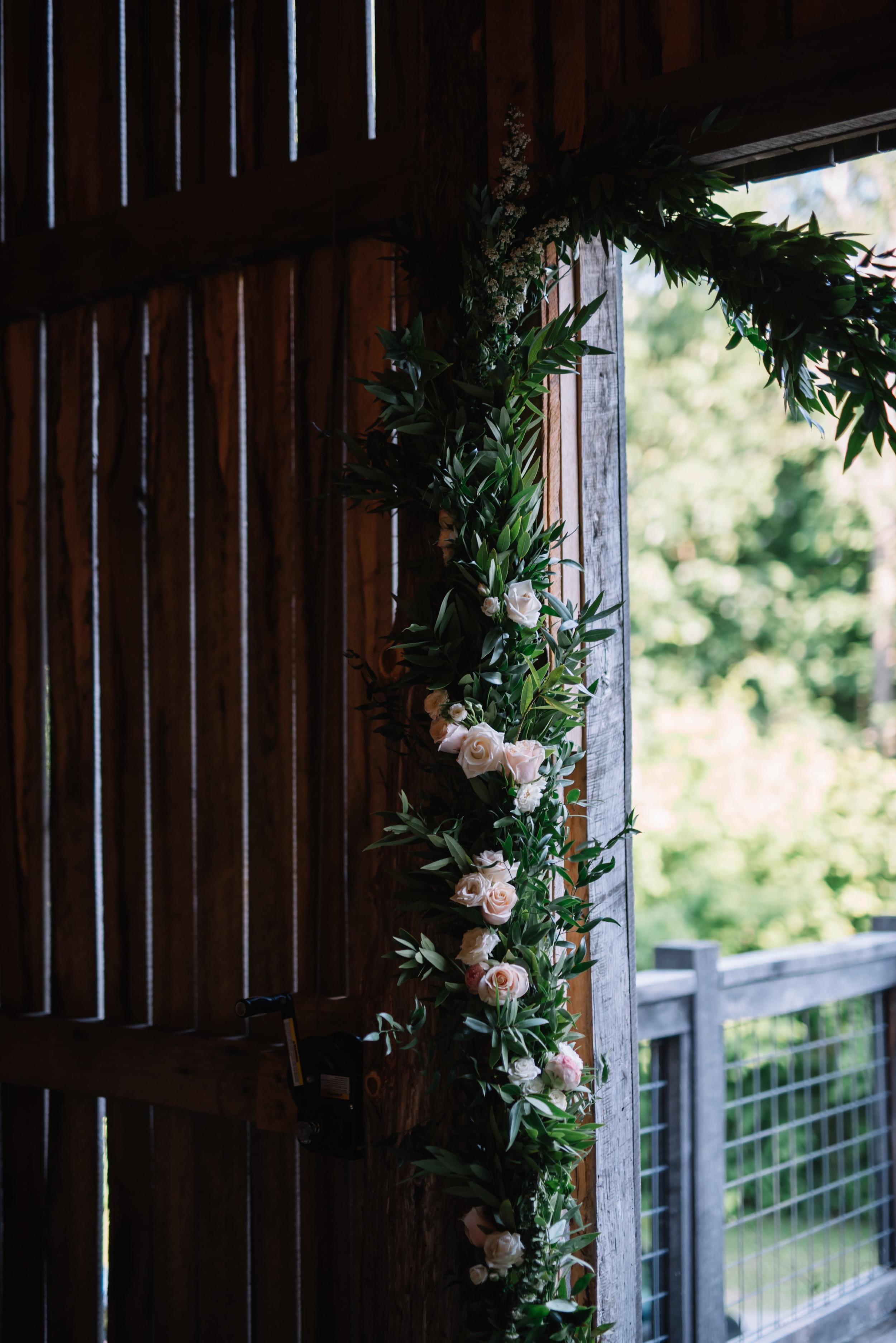 Garland with florals for rustic wedding ceremony backdrop