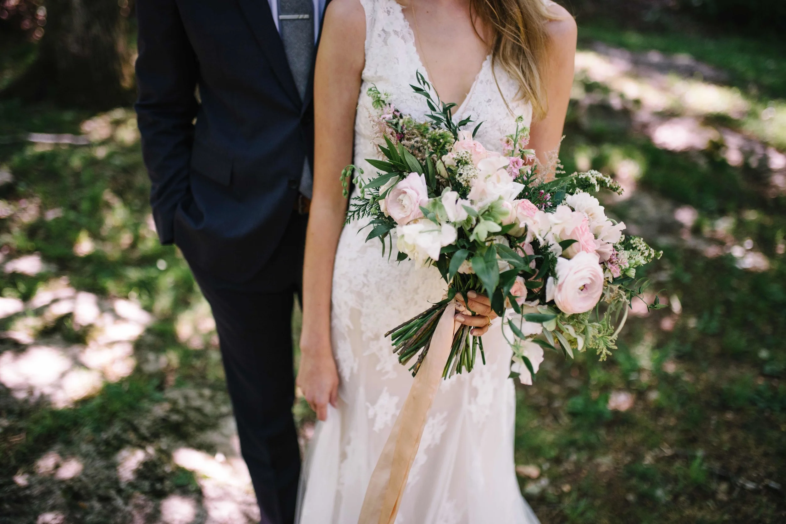 Lush bridal bouquet with pale pink ranunculus and spirea // Springtime Wedding Florals