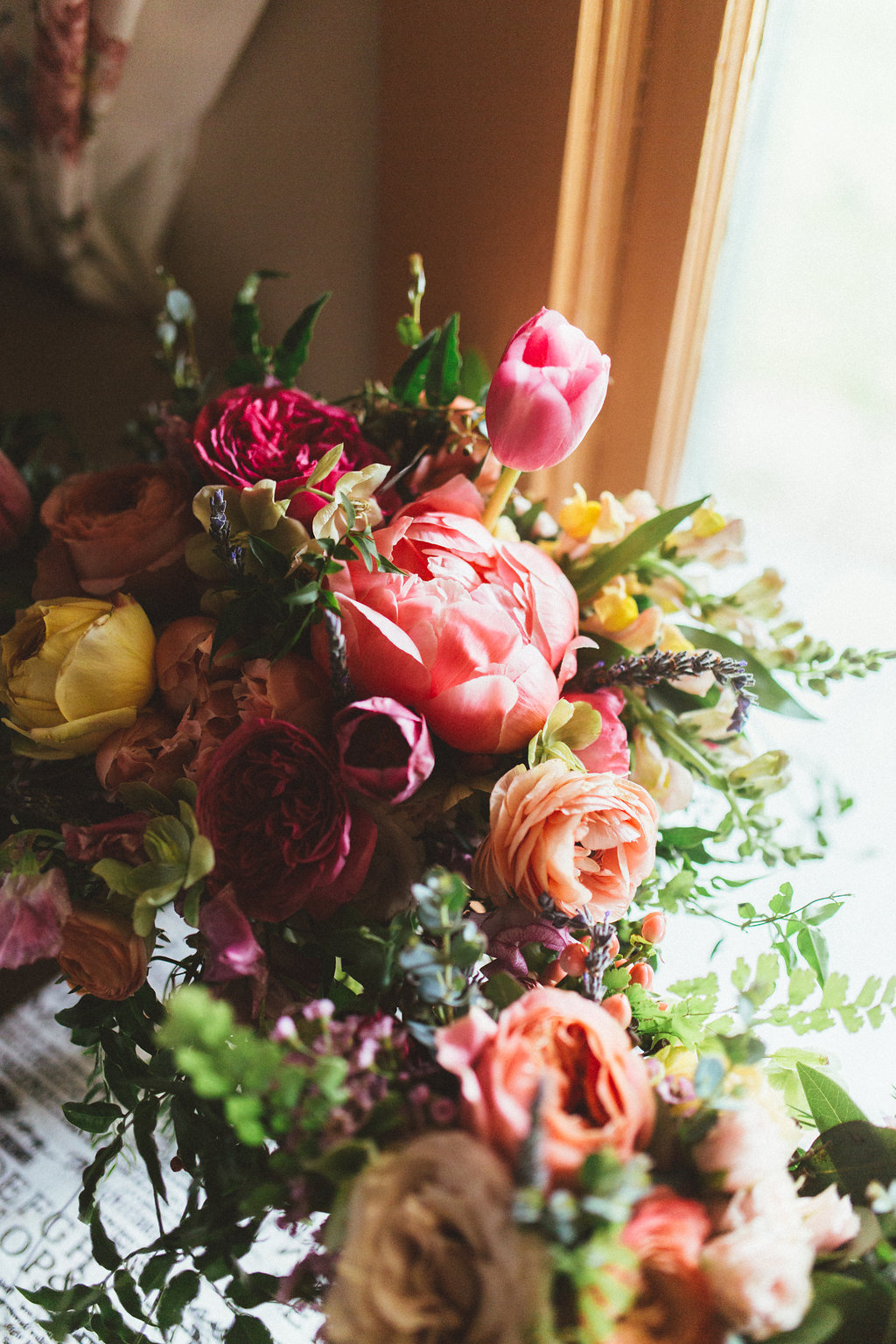 Coral charm peony bridal bouquet with lush, romantic greenery // Nashville Wedding Florist