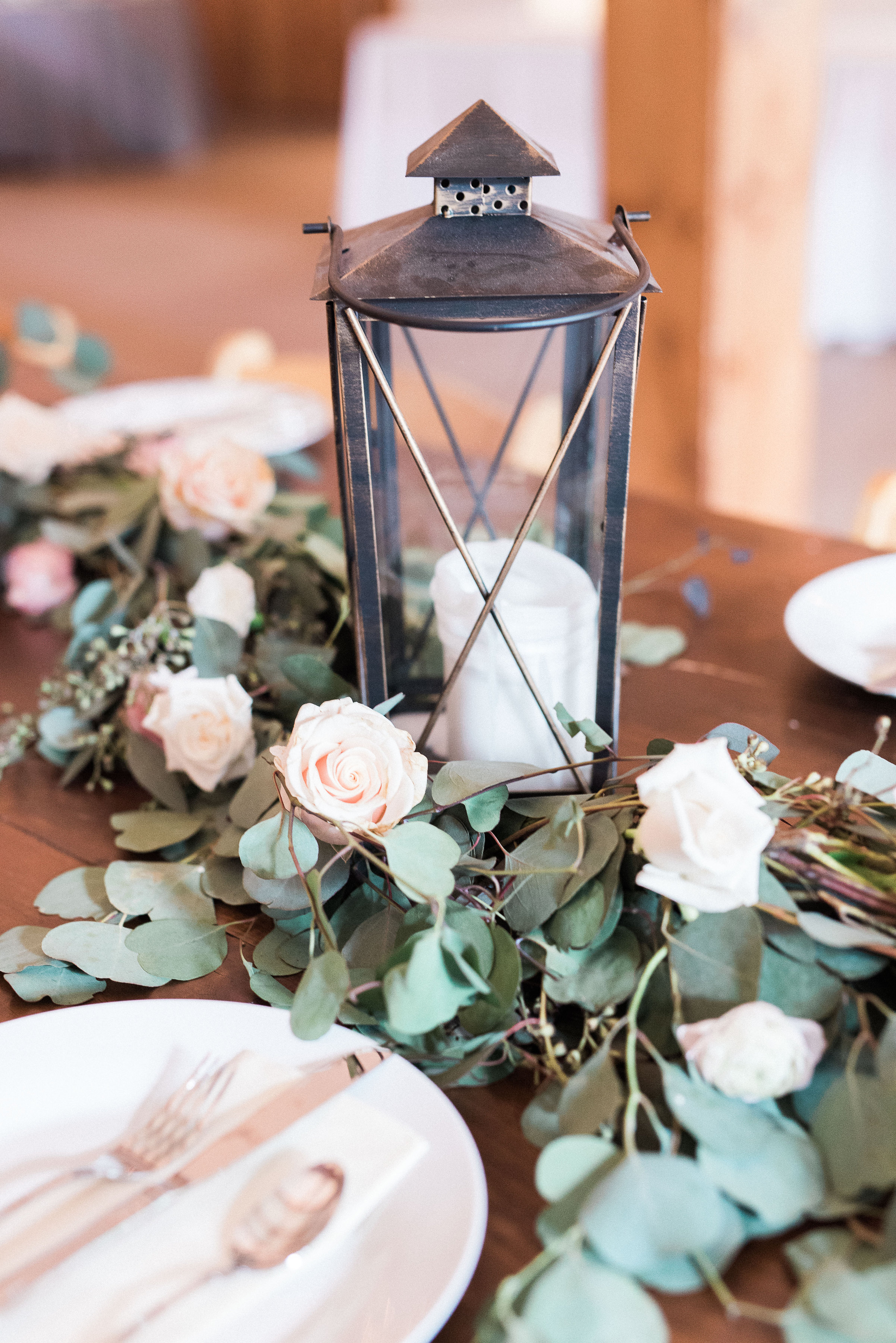 Lanterns with floral and eucalyptus garland for head table // Nashville Wedding Floral Design